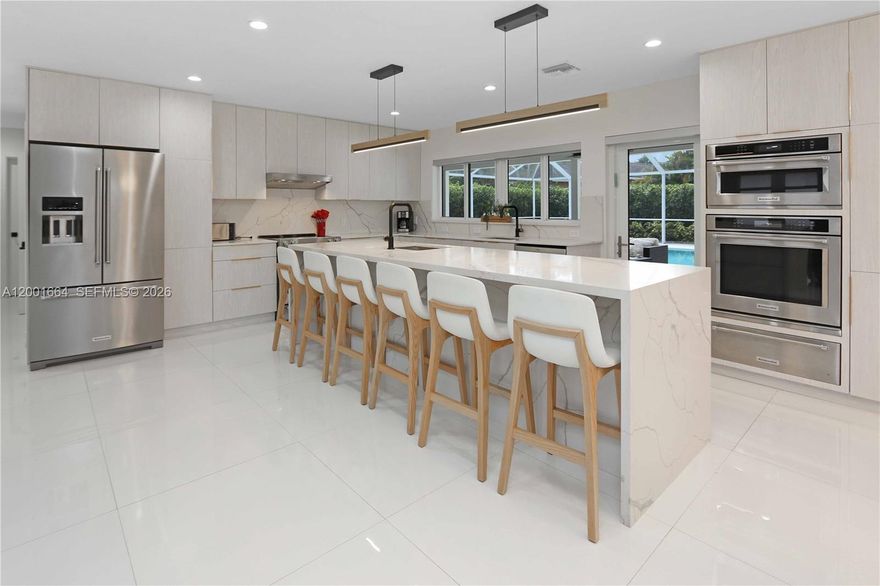 Beautifully remodeled pool home tucked away on a quiet cul-de-sac, offering the perfect blend of style, comfort, and functionality. This spacious 4-bedroom, 3-bath residence features a desirable split and open floor plan, ideal for both everyday living and entertaining.

Step inside through the grand double-door entry and enjoy elegant 24x24 tile flooring, abundant recessed lighting, and a bright, airy layout with expansive living and family room spaces. The home also includes a versatile den/office, currently used as an additional sitting area.

The fully updated kitchen is a showstopper, complete with quartz countertops and a stunning waterfall island, bar seating, KitchenAid stainless steel stove, double dishwasher, double sink, and a convenient pass-through window—perfect for seamless indoor-outdoor entertaining.

Enjoy the luxury of two ensuite bedrooms, while a third bathroom serves as a cabana bath for easy pool access. Bathrooms are beautifully upgraded, including a tub/shower combination with a sleek glass enclosure. Additional upgrades include impact windows and doors, new interior doors, and, per owner, updated plumbing.

Step outside to your private oasis featuring a beautifully landscaped yard, circular paver driveway, and a screened-in pool with a newly built patio—ideal for relaxing or hosting guests. A built-in surround sound system enhances the home’s entertainment appeal.