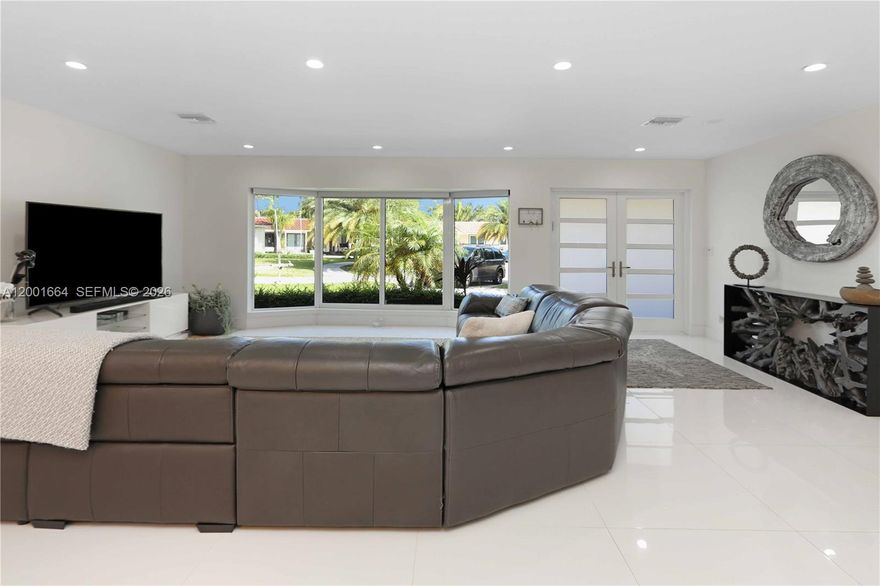 Beautifully remodeled pool home tucked away on a quiet cul-de-sac, offering the perfect blend of style, comfort, and functionality. This spacious 4-bedroom, 3-bath residence features a desirable split and open floor plan, ideal for both everyday living and entertaining.

Step inside through the grand double-door entry and enjoy elegant 24x24 tile flooring, abundant recessed lighting, and a bright, airy layout with expansive living and family room spaces. The home also includes a versatile den/office, currently used as an additional sitting area.

The fully updated kitchen is a showstopper, complete with quartz countertops and a stunning waterfall island, bar seating, KitchenAid stainless steel stove, double dishwasher, double sink, and a convenient pass-through window—perfect for seamless indoor-outdoor entertaining.

Enjoy the luxury of two ensuite bedrooms, while a third bathroom serves as a cabana bath for easy pool access. Bathrooms are beautifully upgraded, including a tub/shower combination with a sleek glass enclosure. Additional upgrades include impact windows and doors, new interior doors, and, per owner, updated plumbing.

Step outside to your private oasis featuring a beautifully landscaped yard, circular paver driveway, and a screened-in pool with a newly built patio—ideal for relaxing or hosting guests. A built-in surround sound system enhances the home’s entertainment appeal.