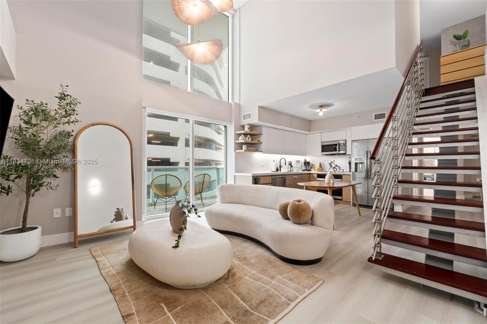 Live in the heart of Brickell in this 2-story condo with 2 beds, 2 full baths, 18-ft ceilings, and floor-to-ceiling windows facing the future luxury towers of Baccarat and Viceroy, adding long-term value. Interior: 1,383 SF (726 SF first level, 443 SF second, 214 SF open space). Terraces: 209 SF total (70 SF, 69 SF, 70 SF). Washer/dryer in unit. 1 assigned parking; 2nd space rentable for $150. Amenities: 2 pools, jacuzzi, gym, spa (steam, sauna, massage), yoga room, game room, conference & club room, dog park, package/mail rooms, valet & 24h concierge. Pet-friendly and investor-friendly, can be rented 12 times/year (30-day min).