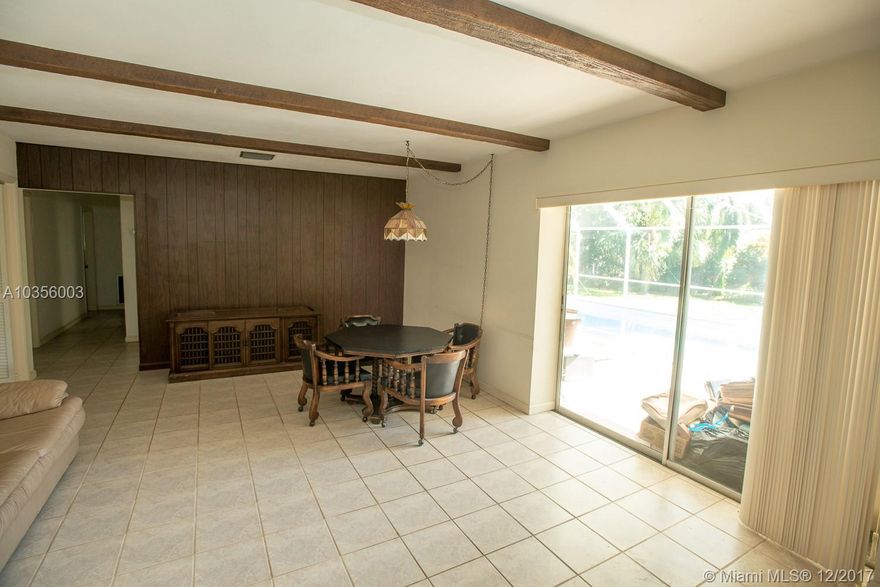 Owner very much motivated, .They are open to reasonable offer..  This home needs TLC  Spacious living space 4 spacious bed rooms ,2 full baths, tiled floors in the general living areas, chef's kitchen, built ins, walk in closets, 2 space attached garage and an screen in enclose  pool. Come enjoy your slice of Florida's paradise here. This lovely lot is just under half an acre. Seller will give up to $1500 for replacement of bedroom carpet  & some broken pool  screen .Make your plans to visit this home today.