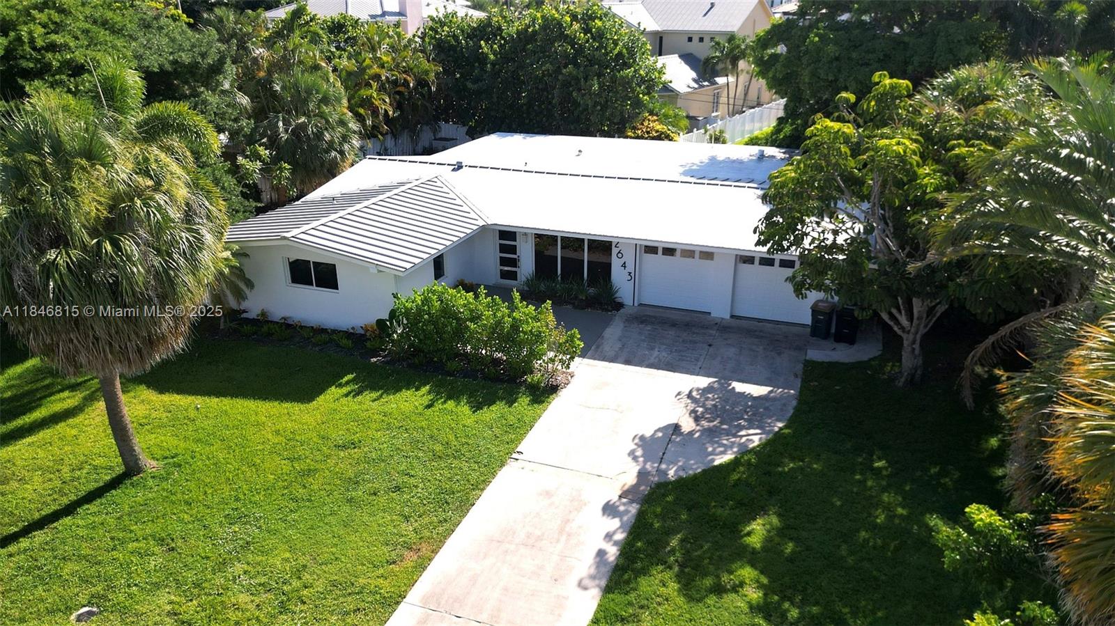 Exceptional 3-bed, 2-bath Pool Home on an oversized 11,519 SF, quiet street, in a desirable enclave of Lighthouse Point, close to the prestigious Lighthouse Point Marina. Substantially renovated with permits, featuring large-format porcelain tile, restored hardwood, and original terrazzo in the bathrooms. Solid CBS construction with hurricane-impact windows, doors, and sliding glass doors opening to a tropical backyard with an oversized, uniquely shaped pool. Includes a custom LED-lit kitchen, closet cabinetry with integrated lighting in all bedrooms, modern interior doors, designer lighting, and updated electrical. The finished garage adds usable space, and masonry, hardscape, and landscaping have been renewed. A move-in-ready home offering comfort, quality, and indoor-outdoor living.