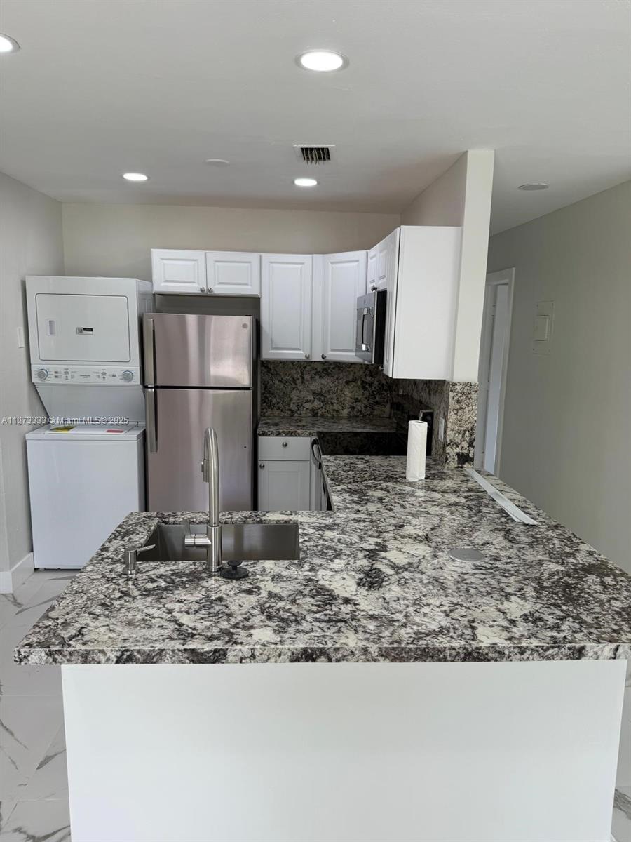 STUNNING, fully renovated 5 bedroom 2 bathroom home with huge private backyard. Primary bedroom includes kitchenette and can be used as standalone efficiency with its own private entrance, bathroom and standalone split AC unit. Excellent location two clicks from the I-95 and right off Sunrise Blvd. Porcelain tiles throughout, brand new kitchen appliances and washer/dryer, spacious and modern bathrooms with frameless shower doors. Brand new plumbing and electric, LED lighting with soft touch switches, and soft close kitchen cabinets. All impact windows and doors. Quiet cul-de-sac street ensures limited through traffic. New fence and driveway.