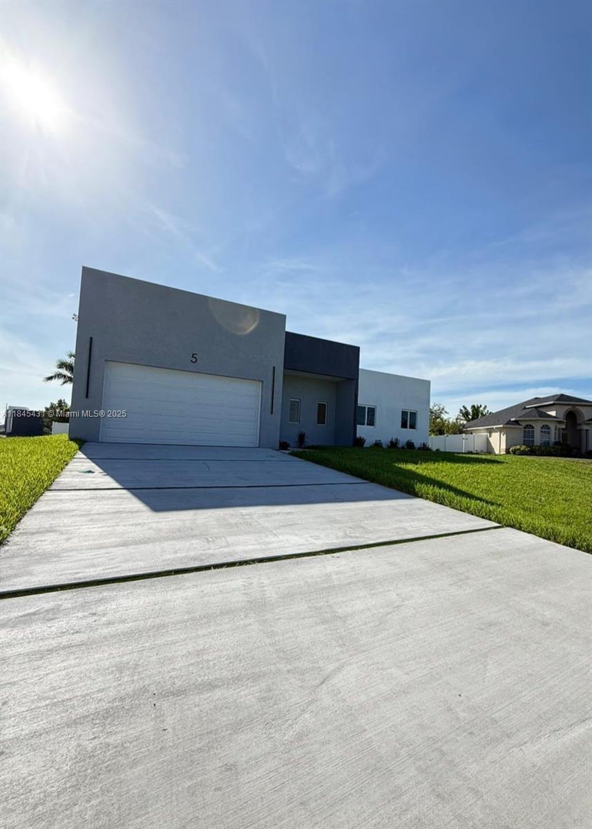 Stunning 3-Bedroom + Open Den Smart Home with sleek design Impact Windows / doors and high-end finishes. This modern layout offers tall ceilings, an open floor plan, amazing kitchen with Coffe / Bar station and a versatile den/office space. Smart features include Alexa system, smart switches, cameras, and Wi-Fi AC control. Chef-style kitchen with stainless steel appliances and Coffee Station, LED mirrors, and a dramatic 16-ft front entrance. Enjoy a outdoor bar/kitchen, ideal for entertaining. The flat roof and gutter system enhance the home’s contemporary style. A perfect blend of design, comfort and technology