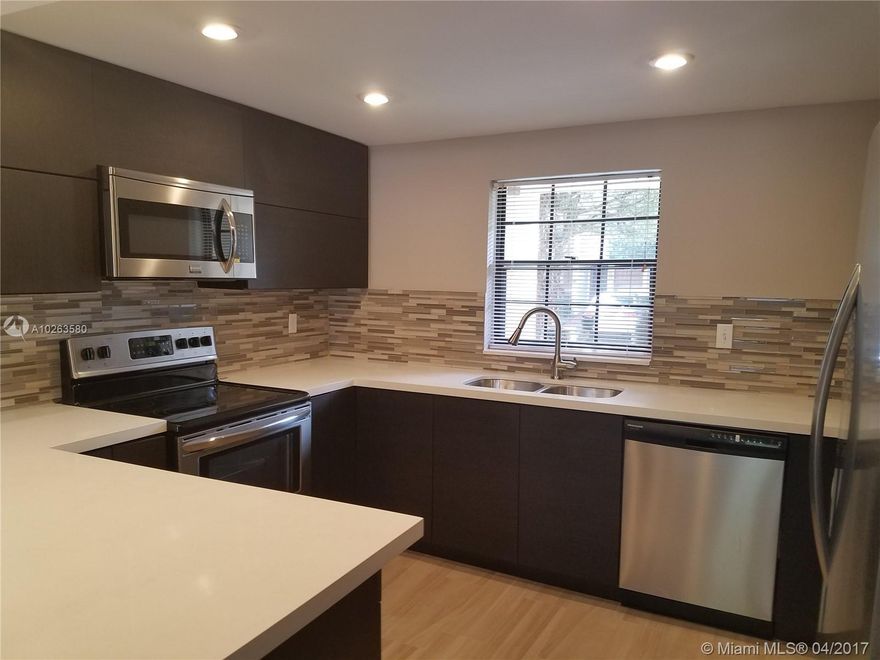 Spacious townhouse in desirable Plantation! 2 Master bdrms
 Great location! Across American Heritage School, this beautiful unit has been totally remodeled,  two stories, gorgeous open kitchen w/ amazing blacksplash, beautiful bathroom design, very modern, latest faucets, fenced back yard,  light fixures, high quality laminated wood floors, split bedrooms, walk in closets, community w/pool & tennis court. Stainless kitchen appliances, high ceilings, washer/dryer. Unique oppirtunity! Non contingent to apprassal.