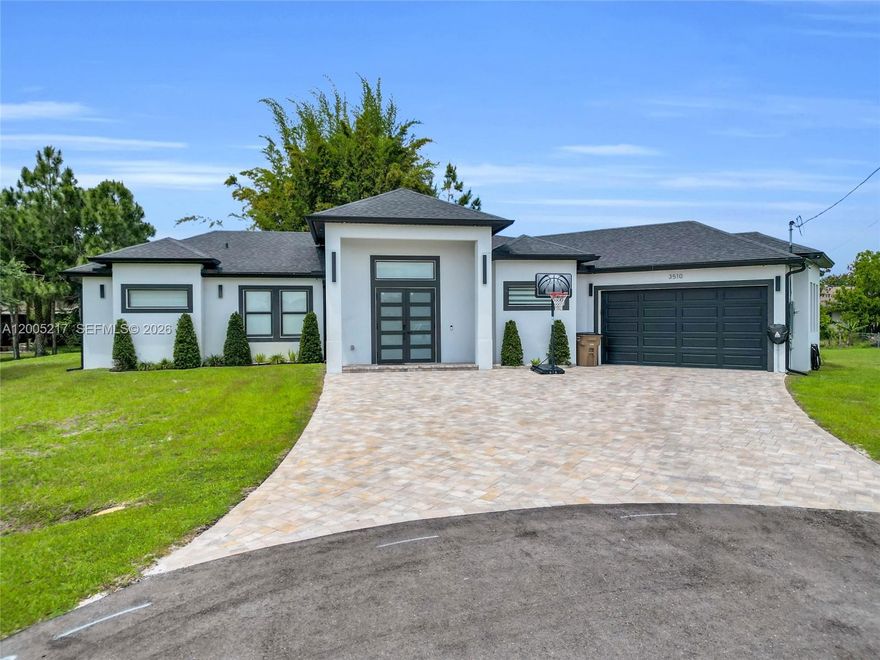 Welcome to this beautifully designed single-family home offering 3 bedrooms, 3 bathrooms, and 1,942 sq ft of living space, perfectly situated on a spacious 0.38-acre cul-de-sac lot. This open-concept home features a modern layout ideal for both everyday living and entertaining. The gourmet kitchen is the heart of the home, showcasing a large quartz island, shaker cabinets, and sleek finishes that continue throughout the bathrooms. The primary suite is a true retreat with a luxurious bathroom featuring double sinks, a separate soaking tub, and a walk-in shower. Additional highlights include impact windows, recessed lighting, and epoxy flooring in the garage for a clean, polished look. Step outside to enjoy the tiled lanai and fully equipped outdoor kitchen—perfect for Florida living and hosting guests year-round. This home combines style, comfort, and functionality in a desirable cul-de-sac location with plenty of space to enjoy both indoors and out.