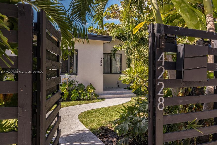 NEWP PRICE, WILL SELL QUICKLY!!! Located near the Miami Design District, Casa Bamboo stands out with its elegant designer interior finishes, including micro concrete wall finishes, wood beam accents and shower glass enclosures. Large impact windows and glass doors flood the interior with natural light. This beautifully remodeled 2 bedrooms, 2 bathrooms, and a versatile den offers the perfect blend of luxury and comfort. Casa Bamboo is truly a slice of paradise, with its professionally designed tropical garden accented with LED lighting. A 10-foot-high bamboo hedge and a charming wood fence provide both privacy and a serene ambiance. The outdoor space boasts an expansive wood deck, perfect for hosting or relaxation. corner lot, the property street parking and a gated driveway.