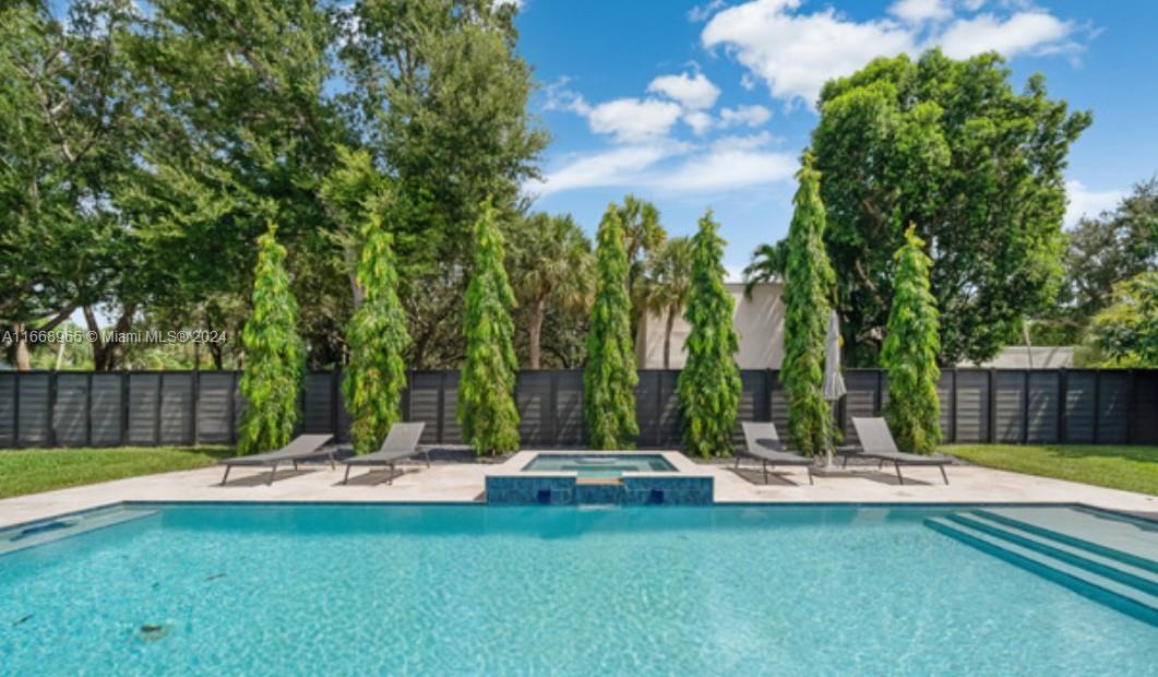 This stunning 5-bedroom, 4-bathroom home offers the perfect blend of luxury and comfort. Boasting high ceilings, built-in closets throughout, a brand-new AC system, and top-of-the-line appliances, the spacious layout is ideal for modern living. Located on a corner lot, it features a beautiful pool, spa, and landscaped garden with a charming porch perfect for relaxing. A new metal fence ensures privacy, while a covered garage adds convenience. Just steps from The Falls Mall, Life Time fitness center, restaurants, expressway, and great schools, this gem is not to be missed!