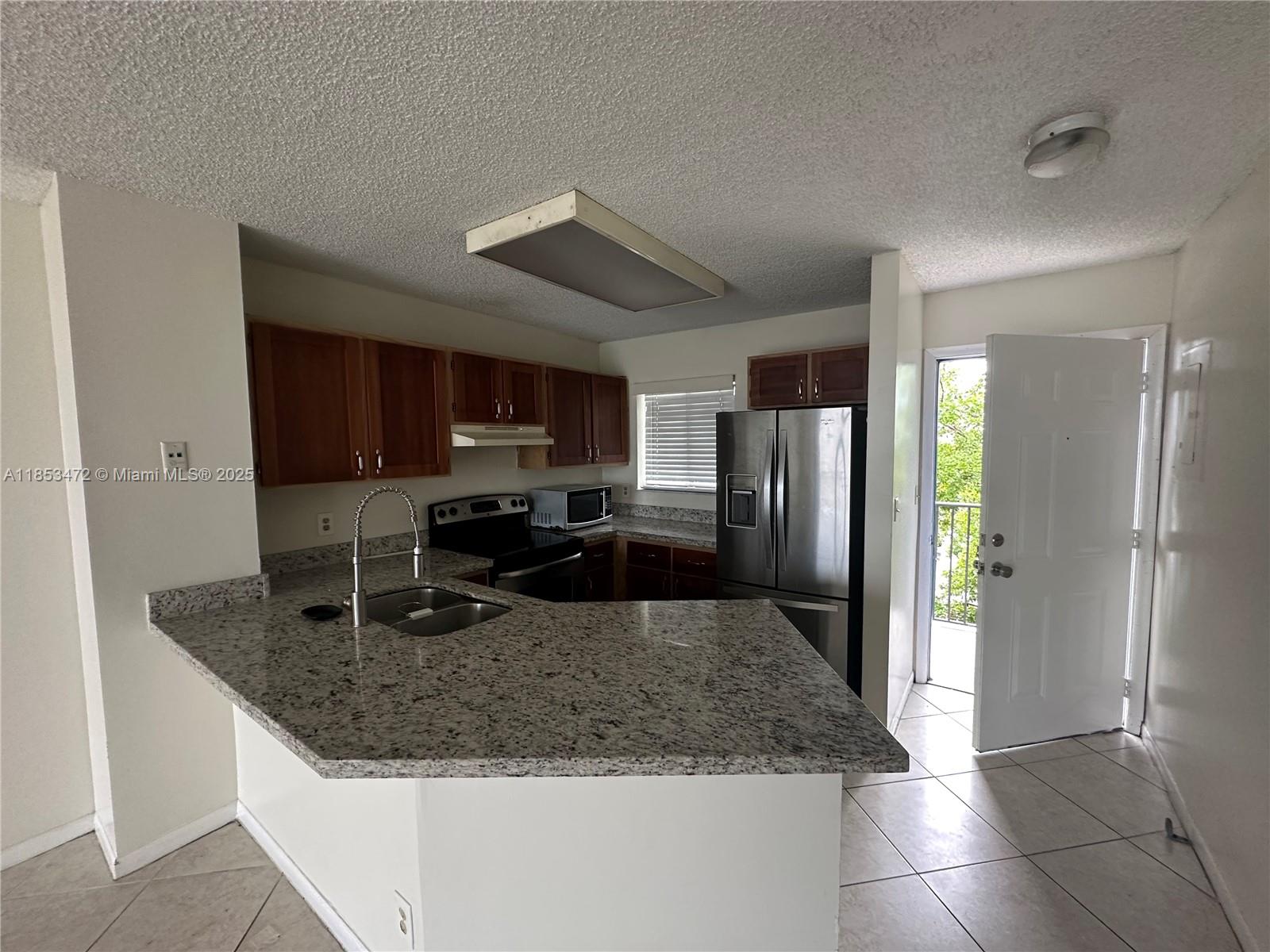 Ready to move in, remodeled kitchen with modern appliances. Washer and dryer inside the unit. All tile floors. Granite counters. Gated community, 24/7 security at gate. Community pool. In House management. Close to major avenues and Turnpike, shopping and schools. FAST APPORVAL (under 5 days)