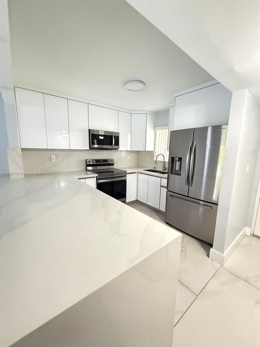 Charming and Spacious unit completely updated 2 bed and 1/2 bathroom. Located on the 1st floor. Perfect for first-time buyers or investors. This unit comes with 2 assigned parking spaces right in front. Windows and impact doors providing security and durability. Washer and dryer are included for your comfort. The Condo is Located steps from Shopping Centers, Hospital, Schools and all major expressways. Flood Zone x. Easy to show, Ready to Move In. Motivated Seller!!