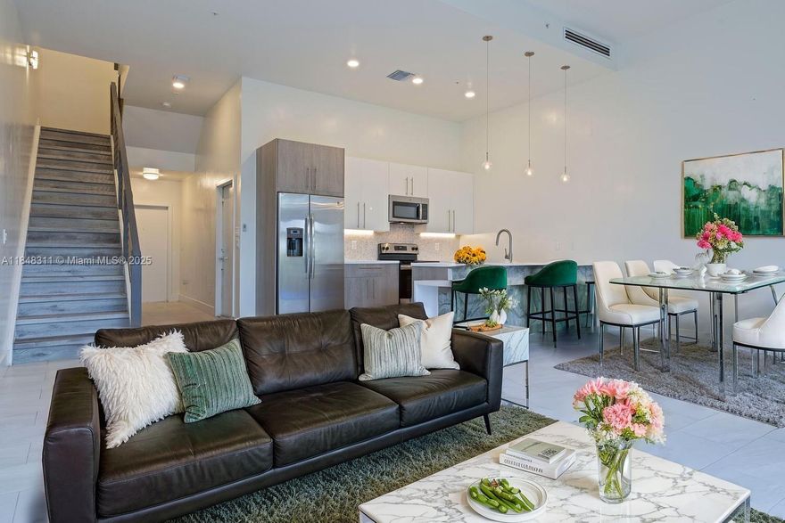 Modern Townhouse in Move-In Ready Condition Located in the Gated Community of Strata Plantation. This Bright and Spacious 3/2.5 Townhome offers a Wonderful Blend of Contemporary Style with 12' Ceilings, Open Concept Kitchen, Sleek Panel Shades, Modern European Style Cabinets, Waterfall Quartz Countertops, Stainless Steel Appliances, Full Size Washer/Dryer and Impact Windows. Ceramic Tile Floors throughout First Floor and Laminate Throughout Second Floor. Primary Suite is an Open and Airy space with En-Suite, Large Walk-in Closet and Open Veranda for Your Morning Coffee or Afternoon Cozy Reads. Resort-style Amenities include a Clubhouse with a Pool Table, Swimming Pool, Gym, Lounge, Dog Park, Children's Playground, and Trails. Flood Zone X! Roof repairs covered by HOA!