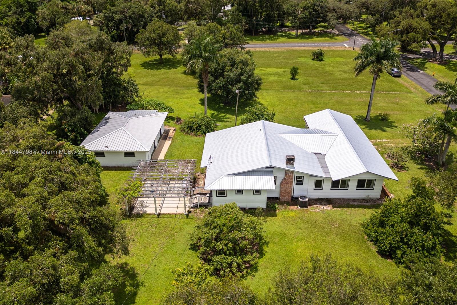 Beautifully restored 1922 LaBelle gem, where classic character blends seamlessly with modern enhancements. 0.90± acre corner lot in one of LaBelle’s most desirable neighborhoods, this home is just a short stroll from Barron Park and LaBelle boat docks. Original features the home’s rich history—hardwood floors, a cozy wood-burning fireplace, vintage ceilings and walls, and even the original clawfoot tub. Recent upgrades including impact-resistant windows, a durable metal roof, updated HVAC system, modern wiring, and stylish fixtures. The spacious kitchen retains its warm country charm, perfect for gatherings and quiet mornings alike. Enjoy the serenity of a screened front porch, a lush yard adorned with fruit trees and vibrant flowering plants, and a detached two-car garage/workshop.