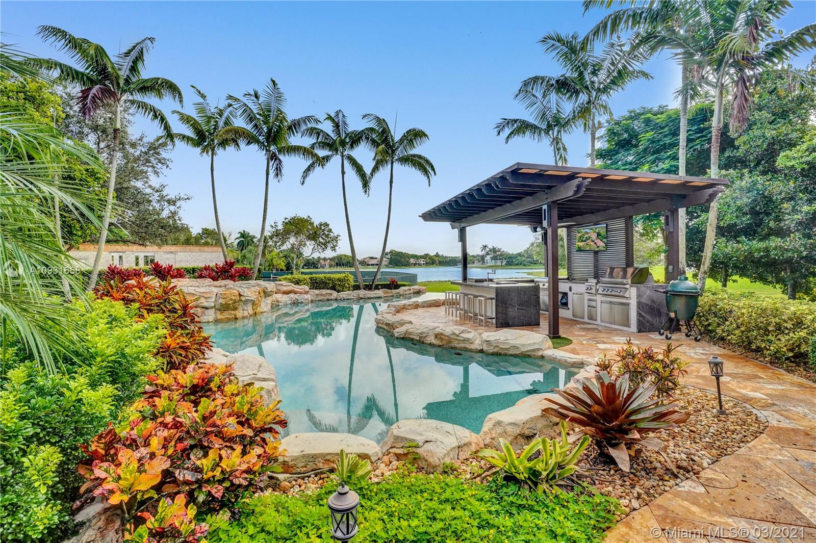 Spectacular & luxurious residence in the prestigious neighborhood of Windmill Ranch Estates. Perfectly nestled on a 1.60 acre lakefront lot with grand entrance, circular driveway, expansive porte-cochere & 4 car garage. This estate with elegant architectural details meets the highest expectations of luxury living. Boasting over 11,000 sq ft under air with 7 bedrooms, 6 baths & 3 half baths plus office, gym, billiard rm with bar, media rm, loft, wine rm, butlers pantry, dumb waiter, elevator & 2 gas fireplaces. Stunning staircase leads you to the master bedroom suite with sitting area, dressing area & spa-like bath. Spacious outdoor patio areas with relaxing views & breathtaking sunsets, infinity-edge pool with raised spa, & a summer kitchen. Hurricane Impact windows and doors through-out.