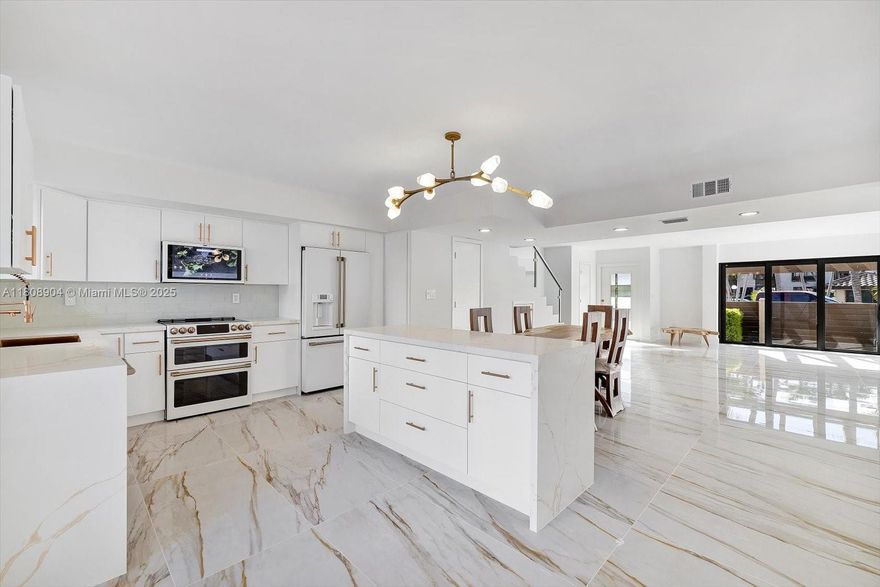 Exquisitely modern and totally renovated two story townhouse on great location. It has 1590 sf, 3 bedrooms 2 & 1/2 bath in desirable Lakeview development on Eastern Shores. Featuring all impact windows & doors, new modern Italian kitchen with island, exclusive Cafe collection of stainless steel appliances, new extra large porcelain floors, new modern bathrooms, in bathroom speaker system, new fence patio great for entertaining, over-sized balcony off master, new lamps plus recessed lighting throughout, all new a/c, high capacity washer & dryer. Steps to the pool area w/ 2 assigned parking spaces and plenty of guest parking. New recently installed roof. Close to the beach , Aventura mall ( Sunny Isles), close distance to restaurants, Oleta Park, Shopping, Houses of Worship, theater & more.