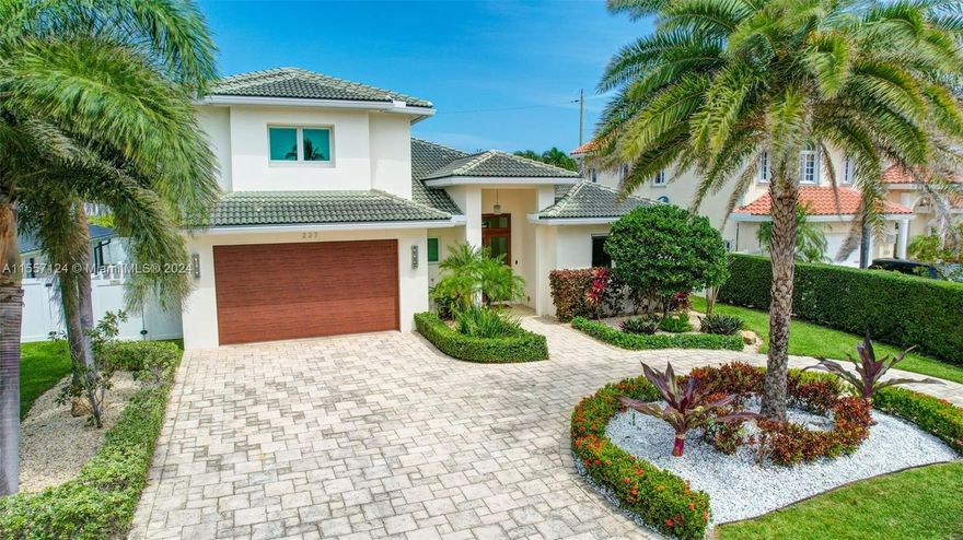 Welcome to your Coastal Modern Beach House!  Built in 2017, this stunning estate showcases 4 en-suite bedrooms, luxe powder room & soaring 12’ ceilings.  Culinarian-crafted kitchen w/ high-end appliances, immense granite island, walk-in pantry, & butler's pantry w/ Avanti wine cooler & new refrigerator.  Formal dining w/ built-ins & wet bar. Bonus theater room w/ automatic blackouts & 8-speaker surround sound.  Expansive sliding doors lead to your covered lanai, loaded summer kitchen, pool, spa & new turf, ideal for indoor-outdoor tropical living. New full house generator, AC unit & fully upgraded Control4 smart home.  Oversized 2-car garage w/storage closet.  Nestled in a quiet neighborhood, 2 blocks from the Intracoastal & 4 blocks from the beach/downtown LBTS.  Luxurious Beach Living!