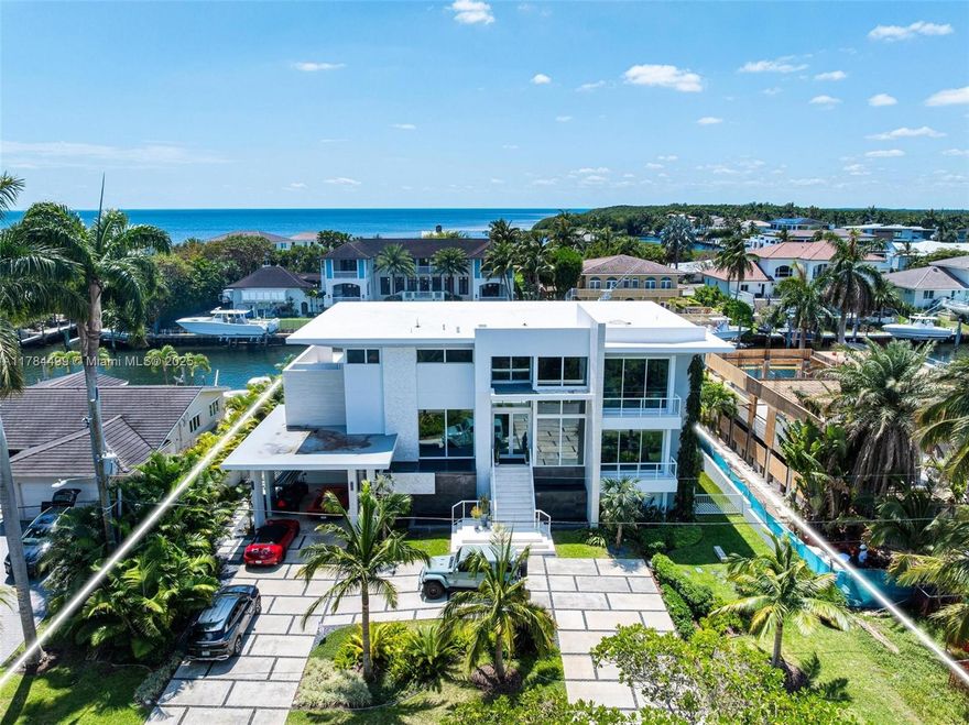 Waterfront luxury reimagined with 100’ of frontage & a 15,000 lb boat lift for up to a 40’ vessel. This 3-story, 9,911 SF smart home blends sleek Italian design with cutting-edge tech. The first floor features a private staff suite, gym, steam spa, staff kitchen, bar, full bath, and a 2,500-bottle wine cellar. The second level stuns with 48x48 marble floors, chef’s kitchen with Miele, Subzero, Italian glass cabinetry, 2 dishwashers, 325-bottle wine cellar, plus office, laundry, and ensuite bedrooms. Upstairs, the primary suite is joined by two additional ensuite bedrooms and a second living room. Fully automated smart home with Control4, 19 security cameras, Trane A/C, ESW impact windows, electric blinds, custom closets, dual kitchens, dual laundries, and A/C 2-car garage. Open Bay Views!