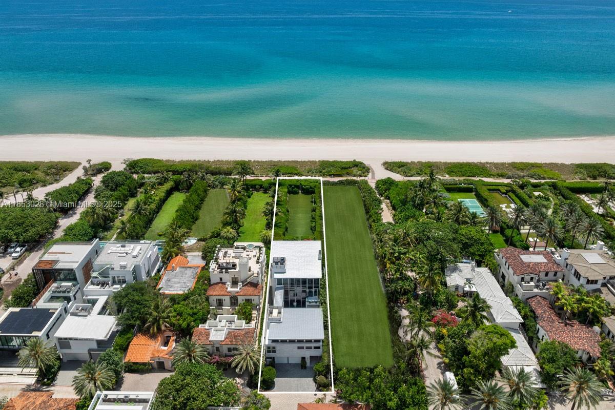 Rising above Miami Beach’s only oceanfront enclave, this contemporary estate by Ramon Pacheco & Coastal Construction spans 3 levels w soaring 11–14’ ceilings, walls of glass & an interior water courtyard. Dual chef’s kitchens w Wolf, Sub-Zero & Gaggenau appliances, multiple entertaining areas, wine cellar & full smart home automation define modern sophistication. The 3rd-floor primary suite offers a private oceanfront terrace & spa bath, while a steam shower at pool level provides the ultimate in relaxation. Outdoors, an updated saltwater pool, summer kitchen, firepit, sunken lounge & refinished stone terraces create a resort-like escape. Enhancements include new A/C, TVs & AV, brand-new driveway, onyx kitchen counter tops, full-house generator, water purification & 2-car A/C garage.