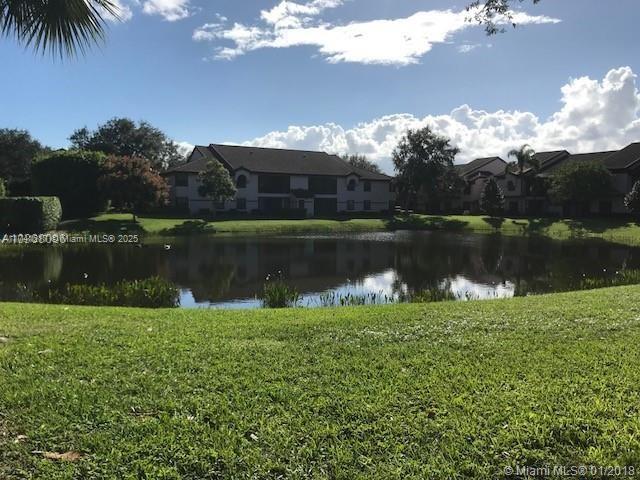 Peaceful tropical paradise. 3 bedroom, 2 bath waterfront home with remodeled kitchen cabinets, newer stainless steel appliances. Granite counter tops in the kitchen. Two double sliding glass doors open to fully screened balcony to enjoy the water views. NO Carpet. 2nd floor corner unit. Lots of natural light. Lake views from every room. Newer washer and dryer. High volume ceilings. Newer fans. Not enough? Walk to the beautiful resort style club house for more fun. Gorgeous pool, tennis courts, gym, poker room, computer room, arts and crafts room, lounge and many more. Man-gated community.