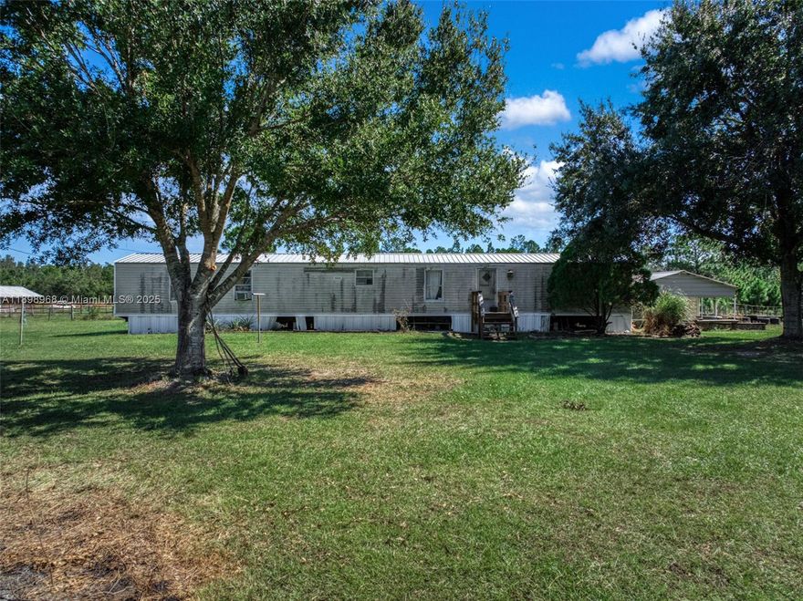 Nearly 5 acres in Lorida of true agriculture land-complete with a mobile home, an outbuilding that has been converted into a cabin like apartment, a tall pole barn, fencing, gated, pond, and some garden areas that just need a little TLC to spring them back to life. The mobile has a newer metal roof (2024) and the inside has a spacious living area/kitchen but it does need work. This property is super unique and is harder and harder to find these days. The property is about , about 20 minutes to Publix and also to Downtown Sebring, 3 hours away from the Miami airport, and under 2 hours to Disney World.