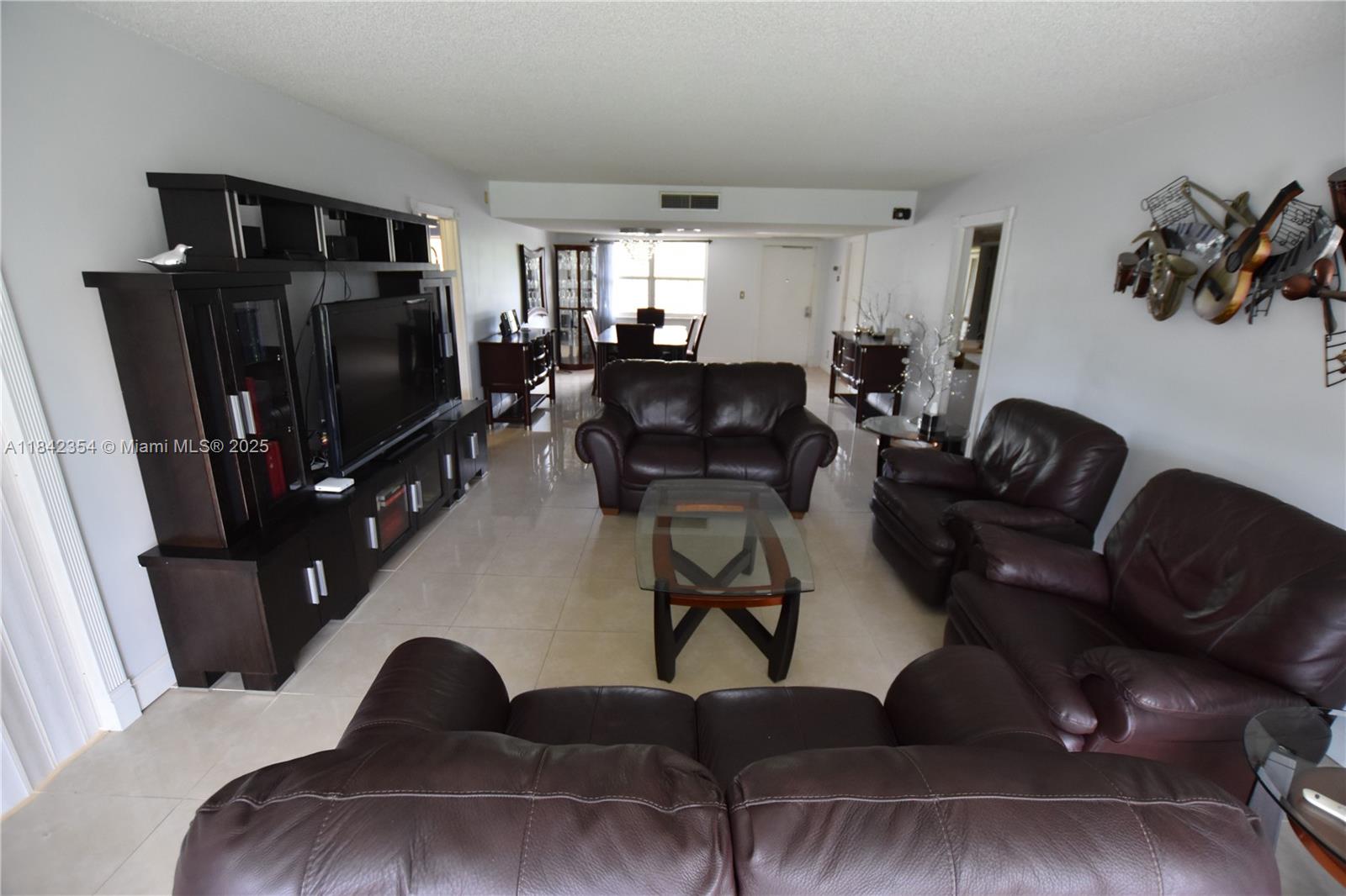 Large 3/2 Split floor plan. Once of the bedrooms can be used as a home office, it has a built in Murphy bed. Both bathrooms updated. Stainless steel appliances in the kitchen and stackable Washer Dryer in unit. Rent price includes water, cable and internet. Amazing bump out patio Facing the golf course is the best room in the house. Association required minimum 700 credit score. only 10-15 minutes from the beach. Will not last!