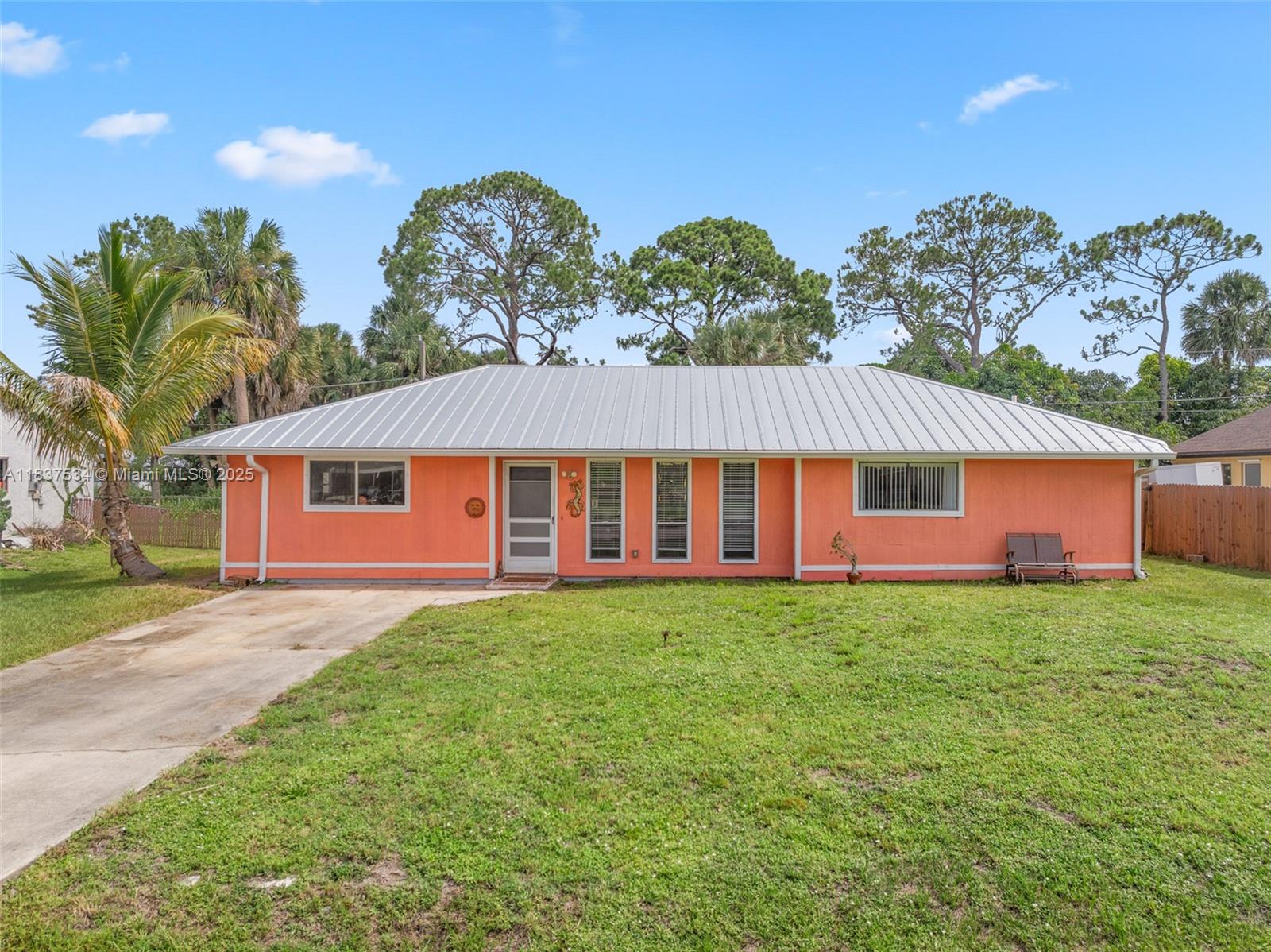 Charming Port Malabar home! 2 beds, 2 baths and converted room in a 1,386 sf single-story layout with updated kitchen and freshly painted interior. New fence, 2019 metal roof, new water heater, upgraded electrical panel w/generator hookup, and attic insulation. Large fenced yard with shed, extra parking, and room for a pool or home expansion. Located on a 10,019 sf lot near schools, parks, and shopping. Move-in ready!