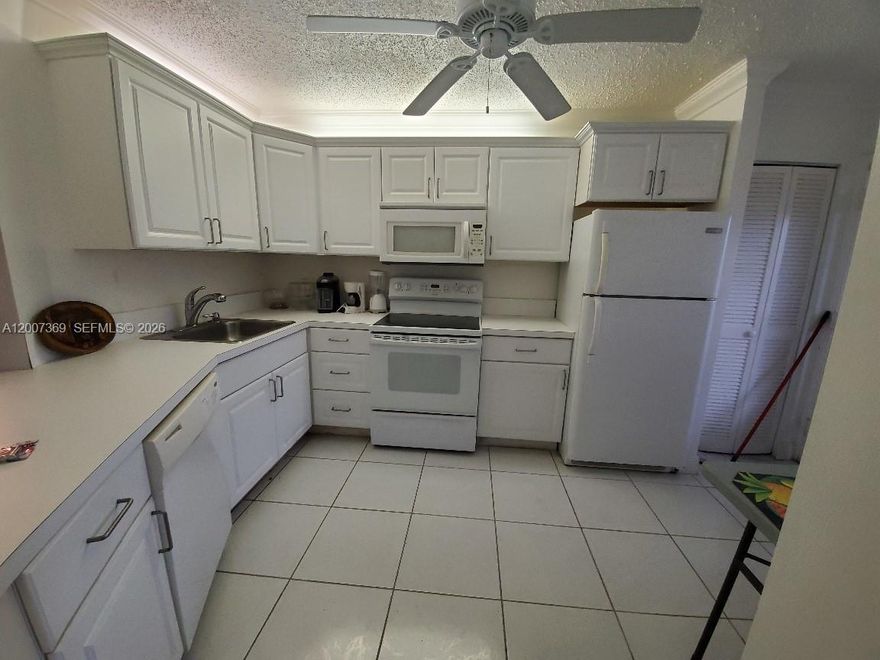 Enjoy comfort, convenience, and peace of mind in this spacious 2-bedroom, 2-bath ground-floor condo set within a secure, gated community. The home features large bedrooms with walk-in closets, tile flooring throughout, and a bright kitchen complete with a dishwasher and microwave. Relax on your screened private porch with serene garden views and easy access to four sparkling community pools. Residents benefit from 24/7 security, laundry facilities on every floor, a fenced pool area, a dedicated mailroom, and one assigned parking space plus guest parking. Ideally located minutes from I-95, top shopping destinations, pharmacies, and grocery stores, this condo offers effortless living in a prime location.