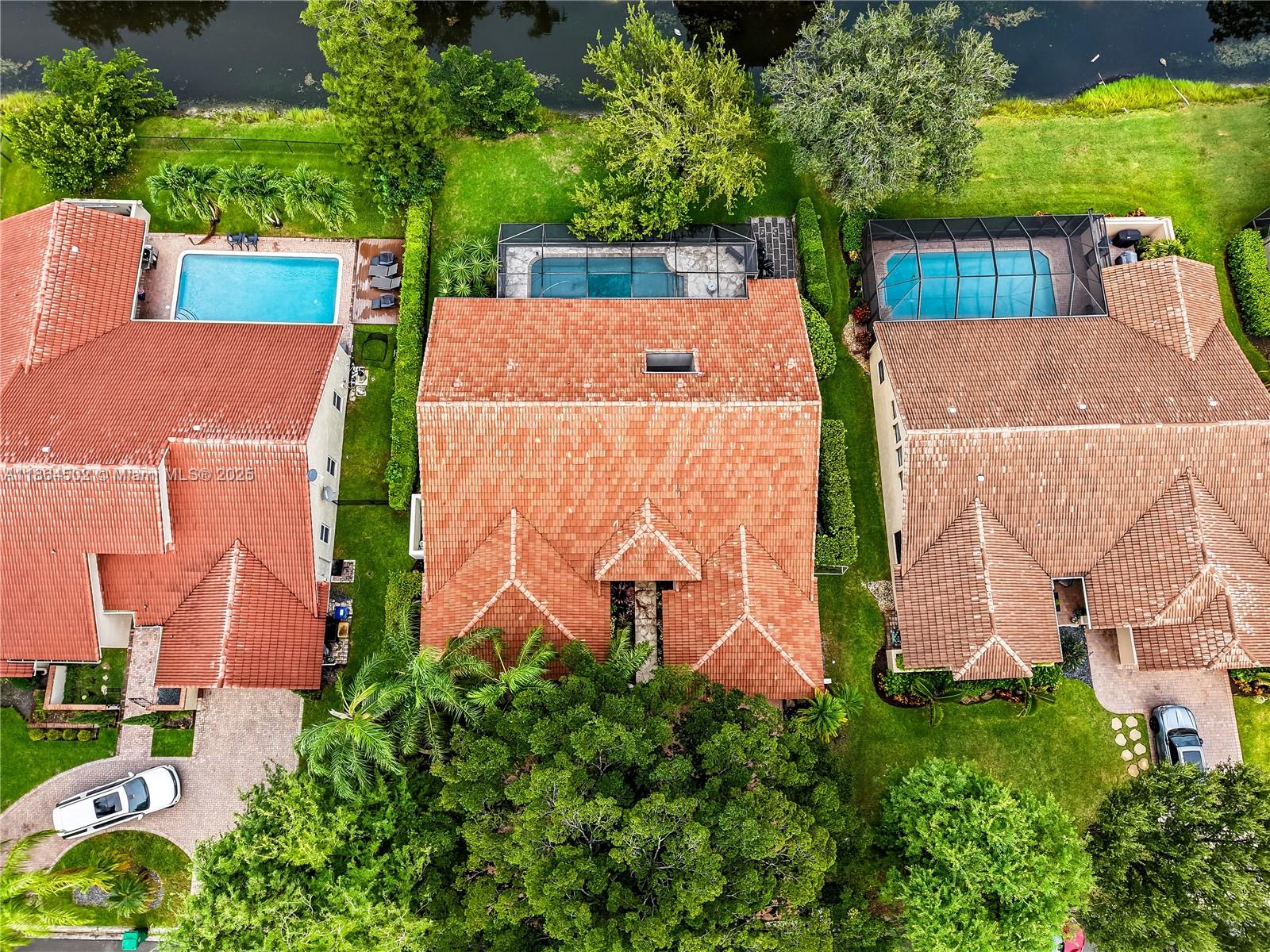 Welcome to your private oasis in highly desirable Pine Ridge, Coral Springs! This beautifully updated 4-bedroom, 2 full, 2 half baths home offers both, elegance and comfort.
Step inside to soaring ceilings and walls of windows that fill the home with natural light showcasing stunning views of the backyard retreat. Enjoy the newly updated kitchen, Black Stainless Steel appliances and renovated modern bathrooms. Primary suite features dual walk-in closets, a spa-like bathroom with soaking tub and separate shower. Outside, unwind on the expansive patio and savor serene water views in true Florida style. Highlights include: NEW impact windows, Updated kitchen with new appliances, Updated Bathrooms, Roof 2006, A/C 2009, This Pine Ridge gem truly has it all — style, space, and location.