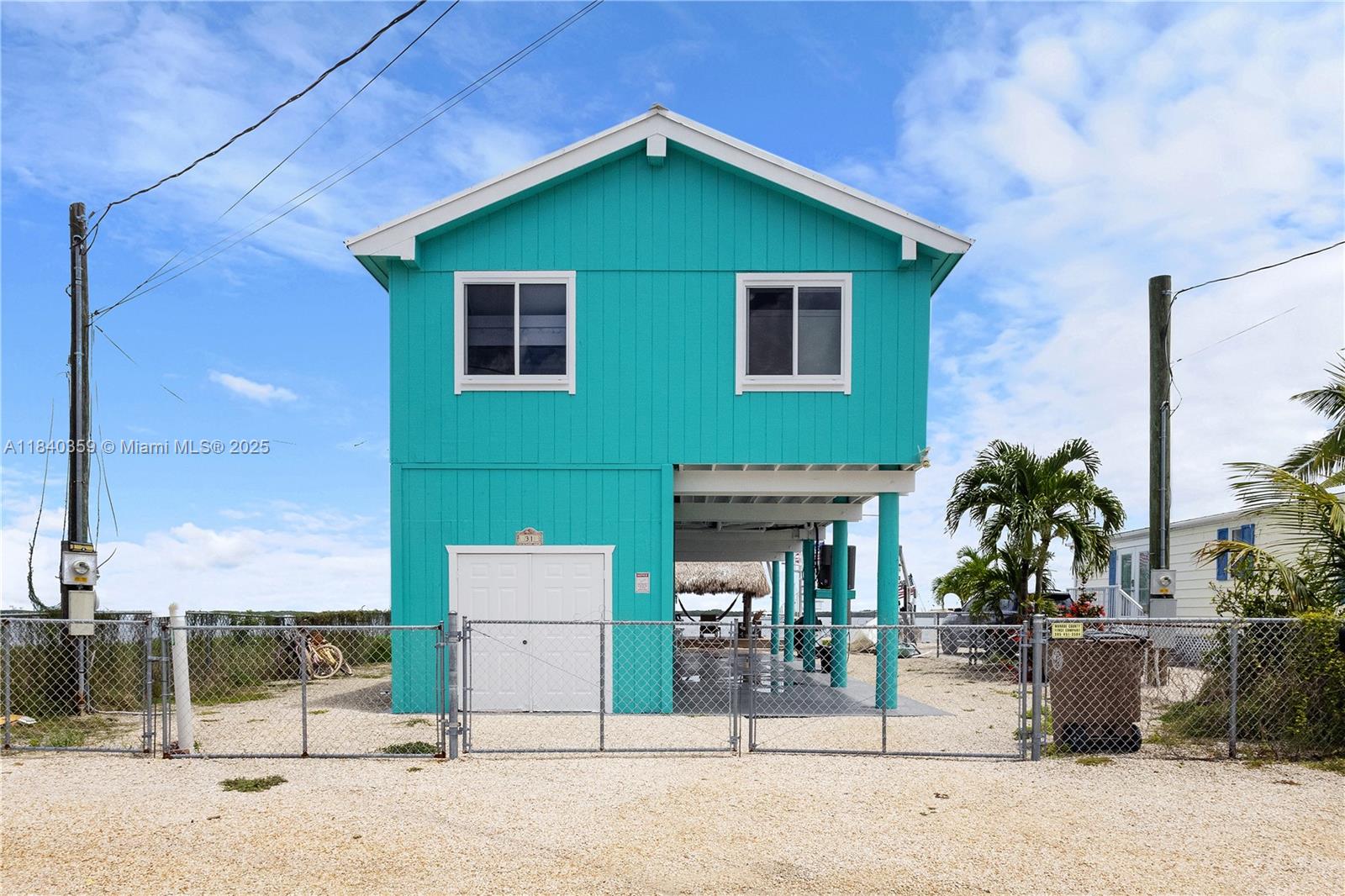 KEY LARGO WATERFRONT HOME, CAPTIVATING SUNSETS AND GREAT AMENITIES. NESTLED IN THE HEART OF PARADISE, THIS HOME OFFERS THE ULTIMATE GETAWAY EXPERIENCE. AS YOU STEP INSIDE YOU WILL BE GREETED BY BREATHTAKING VIEWS OF THE SPARKLING BLUE OCEAN AND EVERY EVENING THE SUNSET WILL LEAVE YOU IN AWE. IT OFFERS 2 BEDROOMS + LOFT & 2 BATHROOMS, IMPACT WINDOWS AND DOORS, FISH CLEANING STATION WITH FRESH WATER HOSE, COMPOSITE BOARD DECK, PATIO & STAIRS. PARK YOUR BOAT HERE UP TO 26FT (10,000 POUNDS BOAT LIFT), LARGE CHICKEE -HUT & SPIRAL STAIRCASE. ELEVATOR/CARGO LIFT FOR YOUR LUGGAGE OR GROCERIES (1000 POUNDS). STORAGE DOWNSTAIRS. HOMEOWNERS PARKS WITH SANDY PRIVATE BEACH, BOAT ROAMPS, DOCK, PIER, PRIVATE SWIMMING AREA WITH BEACH PAVILION. CLOSE TO PUBLIX, TJMAXX, RESTAURANTS, GAS STATIONS & LIBRARY.