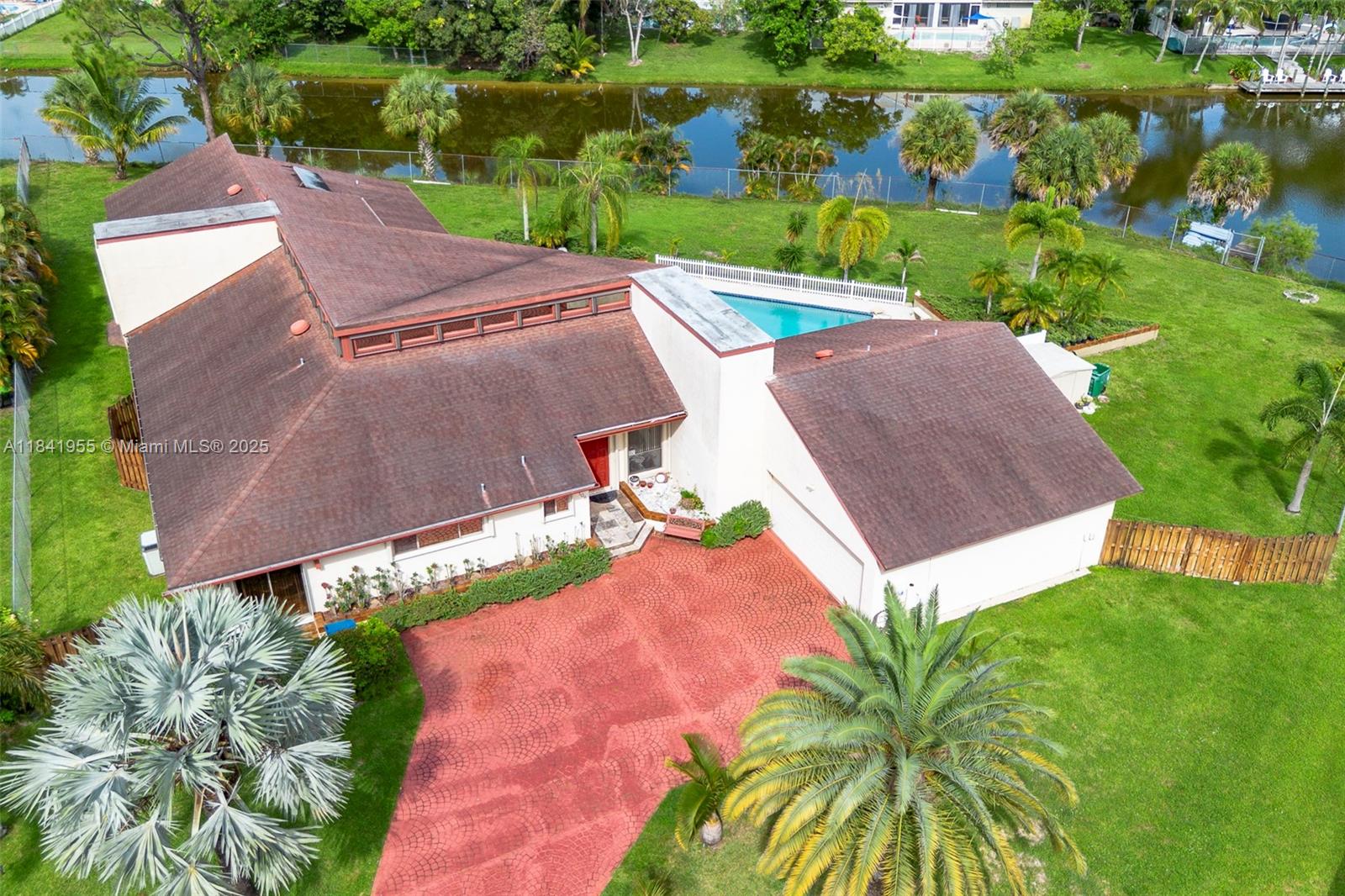 Best deal in Palm Beach County! One-of-a-kind 5BR/4.5BA estate (plus library, another huge office & loft) built by the original developer of Royal Palm Beach as his personal home. Bursting with charm, featuring soaring wood-beamed ceilings, a stunning paneled great room, hardwood floors & oversized rooms throughout. Rear of home offers a private 2BR/2BA suite—perfect for in-laws, guests, or Airbnb income. Includes a large study, loft with 2 additional flex rooms (not under air yet), tons of attic storage, huge fenced yard & a massive pool/deck for entertaining large gatherings. Home needs a new roof & cosmetic updates, but has great bones, tons of potential & is priced to move. List price is the opening offer (net to seller). Offers due Sun., Aug 11 at 1PM. Seller may accept sooner.