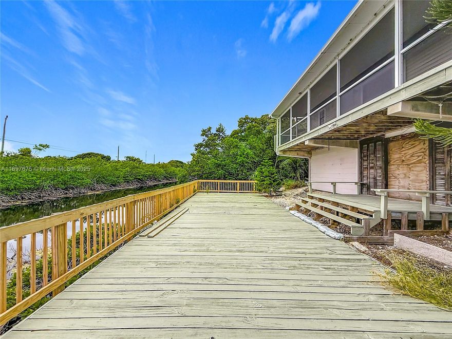 Beautiful canal-front stilt home for sale in Key Largo! This elevated single-family property offers 2 bedrooms, 2 bathrooms, and a bright open-concept living area and open kitchen with a large balcony to enjoy stunning water views and tropical breezes. The ground level includes a finished garage and storage area with plenty of space for tools or water toys. Perfect for nature lovers, the home sits on a private plugged canal. Built in 1985 it has been well maintained, featuring wood floors in the common areas and ceramic tile floors in the bathrooms, central air, and a spacious 4,500 sq ft lot with a paved driveway and lush landscaping. Ideal for vacation living or your Keys getaway — move-in ready and priced to sell!