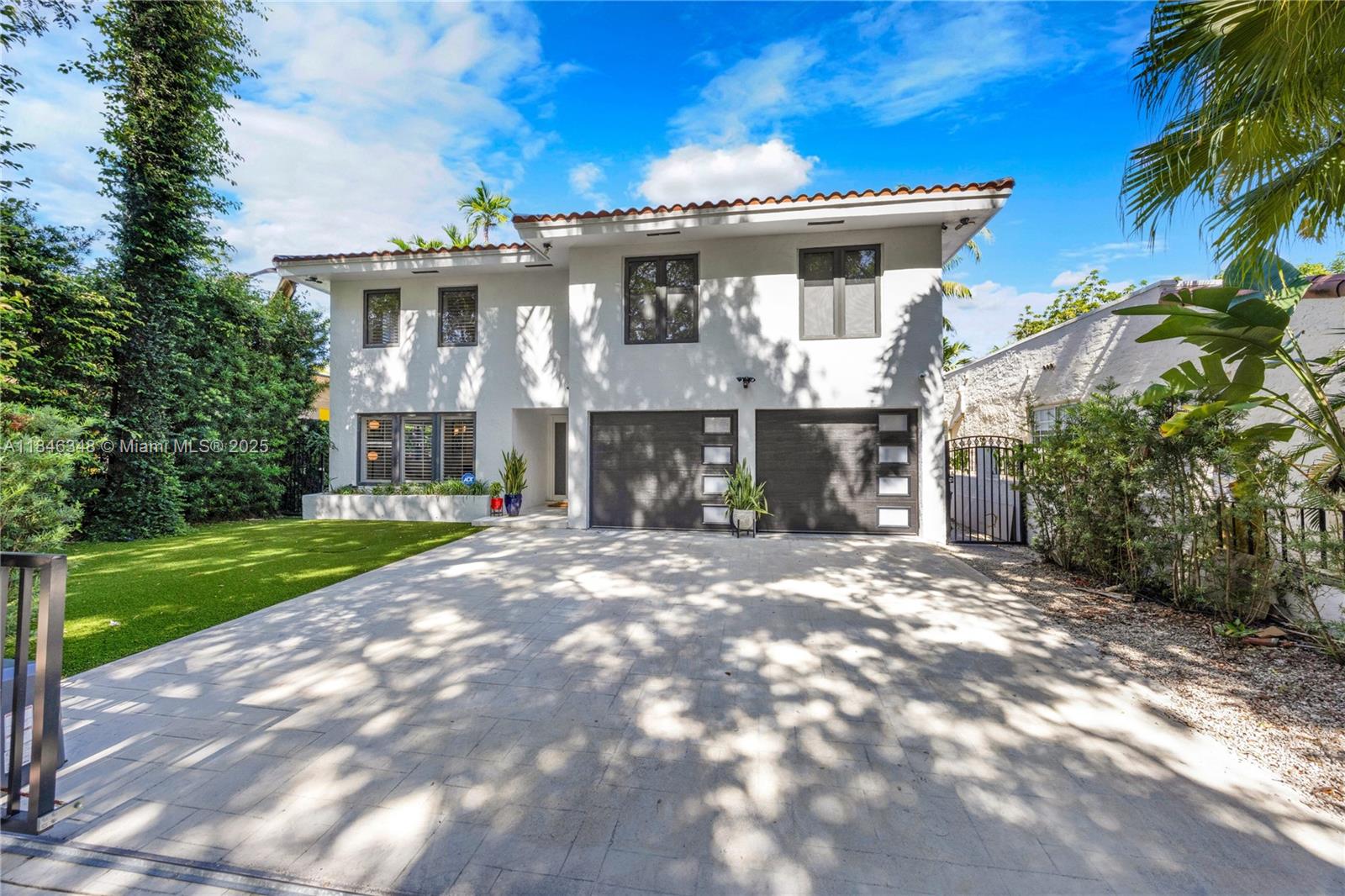 This exquisitely updated 5 BR, 3 BA home spans 2,800 SF and is move-in ready with every high-end feature you could want. The custom kitchen is the heart of the home, featuring premium appliances, butler’s pantry, sleek cabinetry, and large center island ideal for cooking & entertaining. Throughout the home, you'll find updated bathrooms, new ceramic tile floors, contemporary finishes, & curated design details that elevate every room. Step outside to your private oasis, complete with a new summer kitchen—perfect outdoor living year-round. With 2 full laundry areas, 2-car garage, impact windows & doors, & electric driveway gate, this home is as practical as it is stylish, set in a prime Coral Gables location close to UM, Miracle Mile, and more!