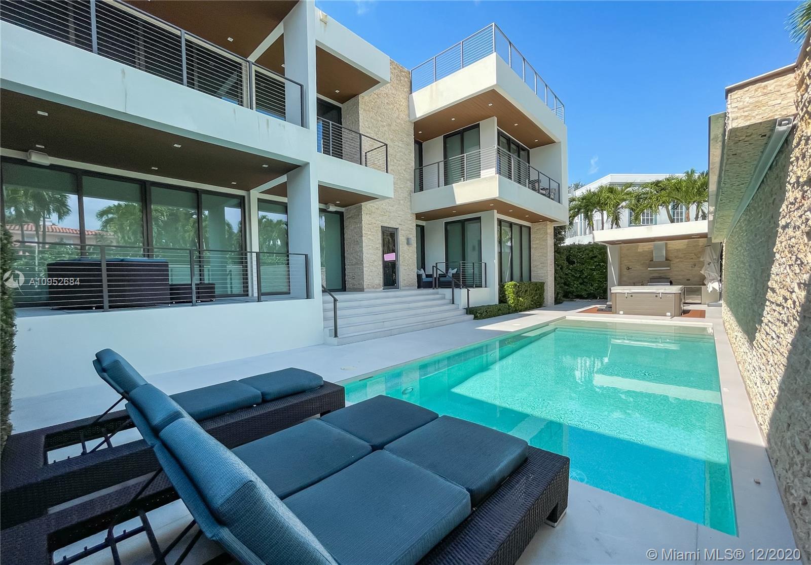 This contemporary, new construction (2015) home by Architect Ralph Choeff features 5 bedrooms and 5,038 SF of adjusted living space. This designer home offers high ceilings, lots of natural light, a modern gas fireplace and top-of-the-line finishes & appliances such as a smart Lutron system, motorized window treatment and a sound system. Large bedrooms with generous built-in closets and private terraces. The state-of the-art kitchen comes with Italian cabinetry and Miele appliances.
The 11.250 SF lot includes a large pool deck with a heated pool, waterfall feature, jacuzzi and shower. Additionally, a cabana with built-in summer kitchen and soft lighting ideal for relaxation and 'al fresco’ dining, A +1,000 SF of roof top terrace with stunning views of the water and the Miami skyline.