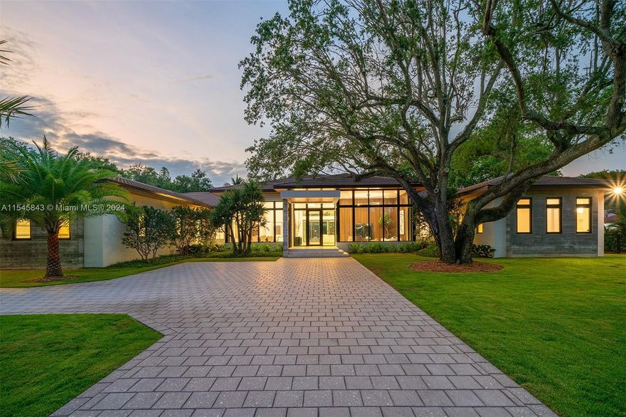 In the heart of North Pinecrest this exceptional single-story residence just completed summer 2024 on a large 175' wide x 223' deep lot. Premium finishes adorn every corner, the kitchen and dining room blend seamlessly boasting sleek lines and ample space for culinary adventures. The living space exudes warmth, enhanced by floor-to-ceiling impact glass windows showcasing breathtaking panoramic views. Adding to the allure of luxury living, a detached guest house connected by a covered breezeway complements the main dwelling. Outside, a lush tropical sanctuary awaits with covered terraces, a heated pool, and a fully equipped summer kitchen. Gated access, media room, gym, full house generator and a three-car garage provide added convenience. Elite Pinecrest Schools nearby.