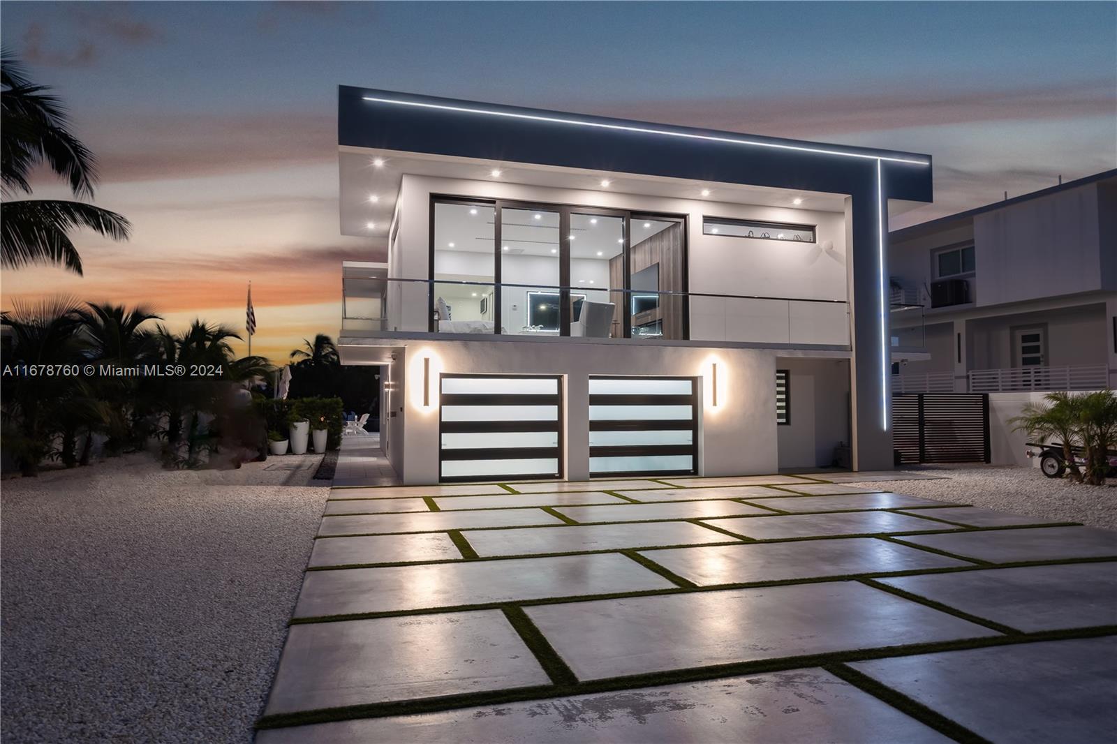 Modern contemporary home offers the ultimate island lifestyle, designed for privacy, security, and seamless indoor-outdoor living. The unique architecture makes it a standout family compound in the Florida Keys. Two-car garage, low-maintenance landscaping. 4 bedrooms and 3 full baths. The upper-level features 2 bedrooms and 2 baths, including a luxurious primary suite with a hidden 14x16' custom closet. Water views, open living, kitchen, and dining spaces. The lower level provides a separate living space with 2 bedrooms, 1 bath, a pool table, and a full custom kitchen. Outside, enjoy 72' of deepwater dockage and a solid concrete seawall, a protected cut-in boat slip with a 15,000 lb lift and direct ocean access!