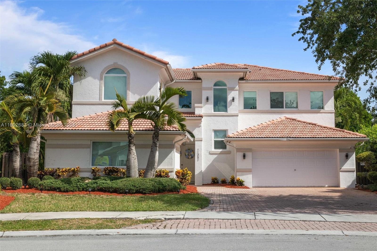 Luxury home in Doral Isles, 3,684 square feet that combines elegance and functionality. 6 bedrooms, including a maid's room, and 4.5 bathrooms, offering comfort and space for the entire family. The ground floor boasts a grand family room and a dining area, creating a perfect space for entertaining and daily living. The kitchen is a showstopper, modern and equipped with top-quality finishes and high-end appliances. Hurricane-resistant windows, Luxurious light fixtures will remain in the property. The master suite includes a large sitting area, extensive closets, and ample storage. The expansive backyard includes a heated saltwater pool and a jacuzzi. The garage accommodates two vehicles, with outdoor space for four additional vehicles, ensuring ample parking for guests and family alike.