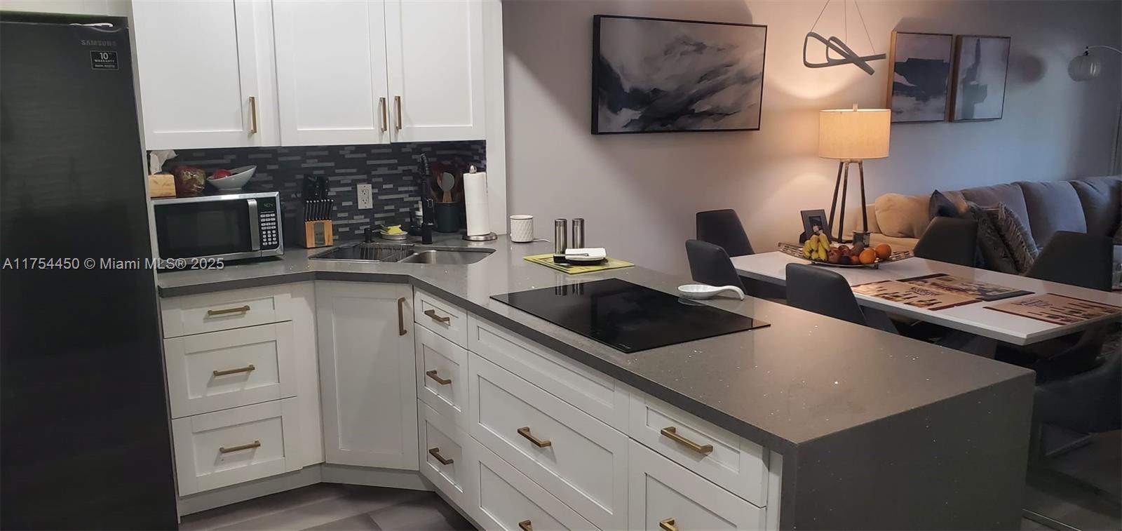 Price dropped $19,910. Seller motivated. This ground floor corner unit has been beautifully renovated, featuring an open floor plan, bathrooms remodeled, a sleek kitchen with Quartz counter tops, custom soft-close cabinets and stainless steel appliances. Enjoy abundant natural light in the Florida room with sliding doors. Split bedroom floor plan for your privacy. The unit features a 2024 AC compressor coil, 2024 water heater with pan, laminate flooring throughout, and no popcorn on the ceiling. HOA fees include internet, cable tv, water, sewer, garbage removal. The clubhouse has a resort style heated pool, with tiki huts, BBQ area and tennis courts. Gym with locker rooms, sauna and steam room. The building has an elevator, laundry facility with newer washers and dryers and storage rooms.