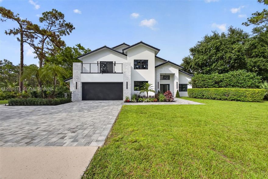 Step into a fully remodeled 5-bed, 4-bath equestrian estate on nearly 7 private, fully fenced acres. Reimagined with professional design, the residence features all-new systems: roof, impact windows and doors, updated plumbing and electrical, and whole-property irrigation. Inside, custom Lioher cabinetry is showcased throughout—including all closets. The chef’s kitchen centers on striking Cristallo countertops with generous prep and storage, flowing easily to the main living areas for everyday living and entertaining.

Spa-inspired bathrooms are newly finished with designer tile, frameless glass enclosures, sleek vanities with integrated storage, premium fixtures, and thoughtful lighting—delivering a fresh, modern look and low-maintenance durability.

Automatic gates open to expansive grounds with a new heated pool and a well-appointed outdoor kitchen, creating a seamless indoor-outdoor lifestyle. Purpose-built equestrian facilities include elegant stables with chandeliers, a tack room, feed room, bathroom, and an office/kitchen area—plus 12 full-size horse stalls and 13 mini-horse stalls. A state-of-the-art riding arena and multiple paddocks support training and turnout.

Thoughtful updates, durable finishes, and a practical layout deliver comfort, resilience, and ease of maintenance—combining privacy, amenities, and comprehensive equestrian infrastructure in one rare package.