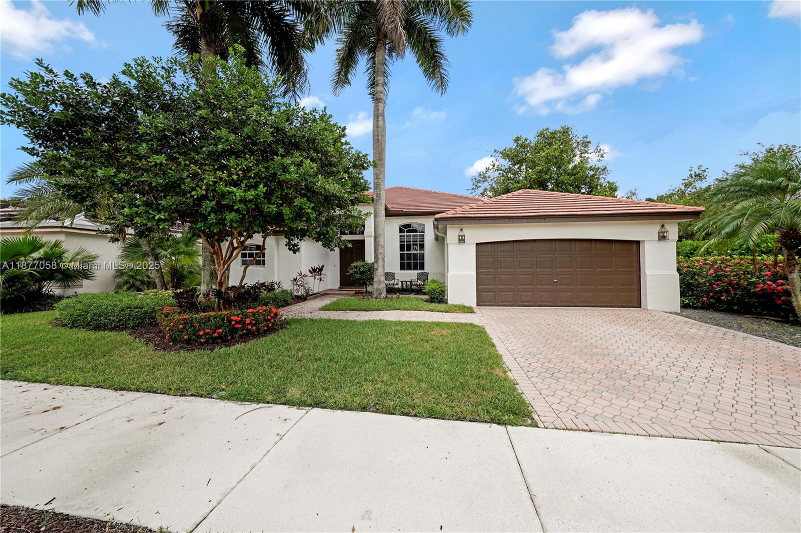 Don't miss the opportunity to live in Weston Hills Country Club. Porcelain flooring through-out. Modern bathrooms and kitchen with quartz countertops and stainless steel appliances. brand new Energy efficient air conditioner. Enjoy a split floor plan with 4 bedrooms and 3.5 bathrooms, formal living and dining, and spacious family room. Steps from the park with a playground, soccer area, pickleball/basketball court. Screened-in patio area. Designated A+ Weston schools with bus pickup at the corner. Great family neighborhood within Weston's only golf/tennis country club community. Schedule a showing and experience the best of Weston