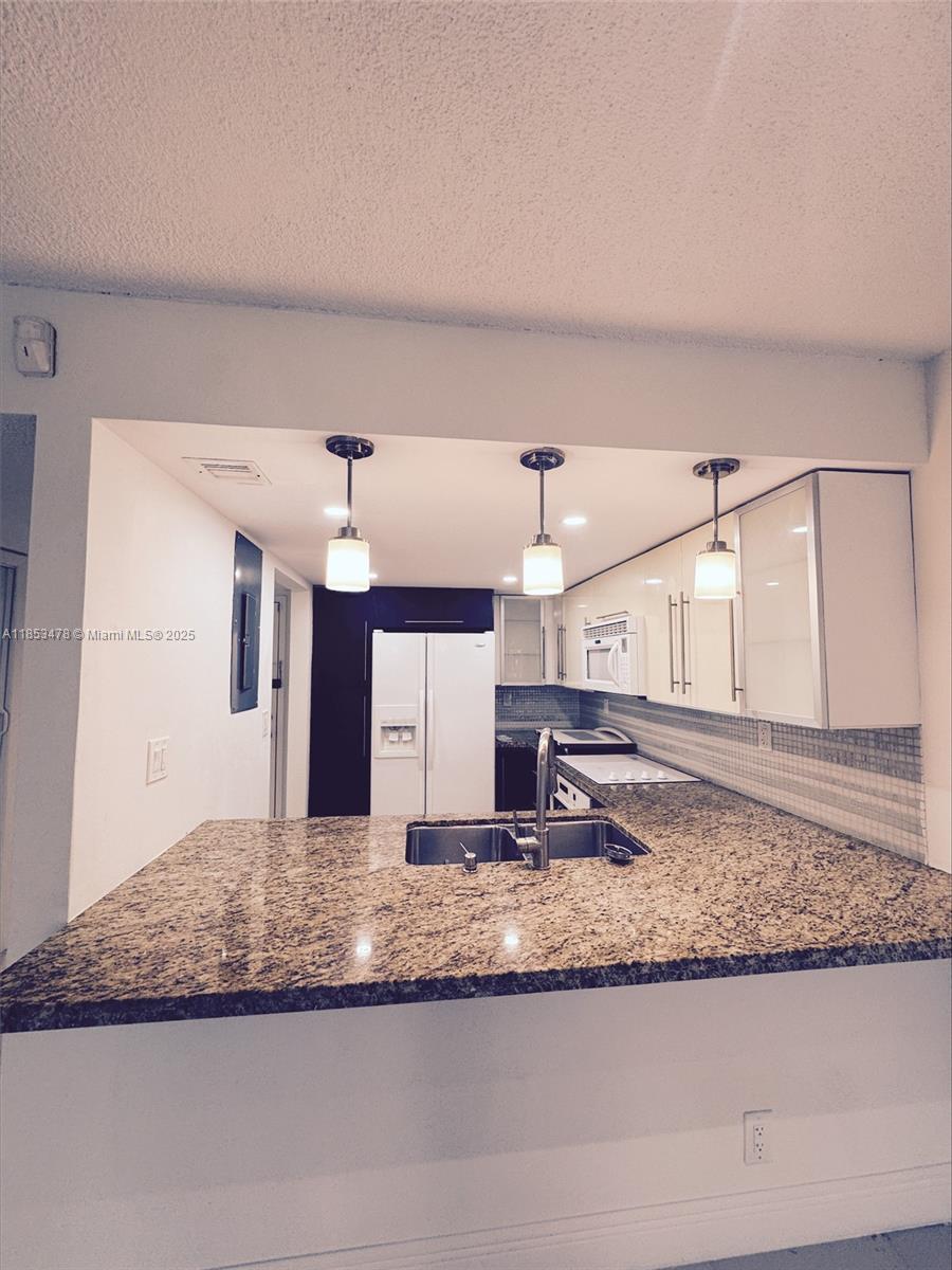 Completely remodeled and oversized 1 bed / 1.5 bath waterfront condo! This beautifully updated unit is conveniently located on the first floor of a secured building and features a spacious layout with large ceramic tile floors, impact windows, and a fully renovated kitchen with modern appliances. The oversized bedroom includes a walk-in closet and opens to a private screened patio with tranquil water views—perfect for relaxing or entertaining.
As a resident, you’ll enjoy access to the prestigious Bonaventure Town Center Club, offering resort-style amenities including two pools, jacuzzi, tennis and racquetball courts, gym, billiards, library, bowling alley, tot-lot, media room, roller skating rink, basketball court, and more!