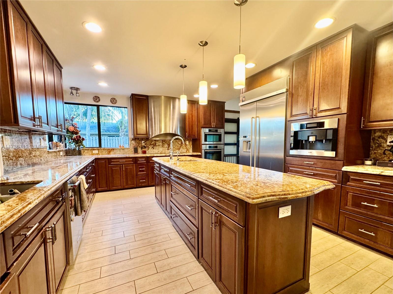 Peaceful Oasis in highly sought Sherwood Park. NO HOA! Location! Location! This large corner lot is centrally located in Delray Beach, close to everything! Downtown Atlantic Ave, shopping centers, Only 10 minutes to the Beach, 30 min to FLL and 22 min to PBI. This beautifully unique home has vaulted ceilings with cedar wood accents, Huge full chef kitchen with Miele, Gaggenau & KitchenAid appliances and full marble bathrooms. An indoor/outdoor surround sound speaker system & full stone covered wood burning fireplace for true luxury! The backyard features a large stone waterfall with shallow pool, great for kids and parties! Impact Pela doors and windows throughout & modern lofted vents are just some of the impressive features of this gorgeous home!