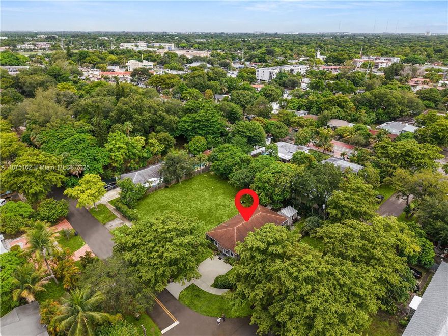 Exceptional 2019 home on an expansive 18,600 sqft corner lot. An open floor plan filled with natural light from hurricane-impact windows connects spacious living and dining areas to a sleek kitchen with high-end appliances, including a glass cooktop and dishwasher. Three generously sized bedrooms and two thoughtfully designed baths , and inside laundry for everyday convenience. Step outside to a patio and yard framed by mango and avocado trees, creating a peaceful, tropical setting to enjoy year-round. A detached backyard structure provides versatile space for a studio, guest quarters, or workspace. The oversized lot is large enough to subdivide and build an additional residence, with two separate water meters and a gated entry for independent access, offering unique development potential.