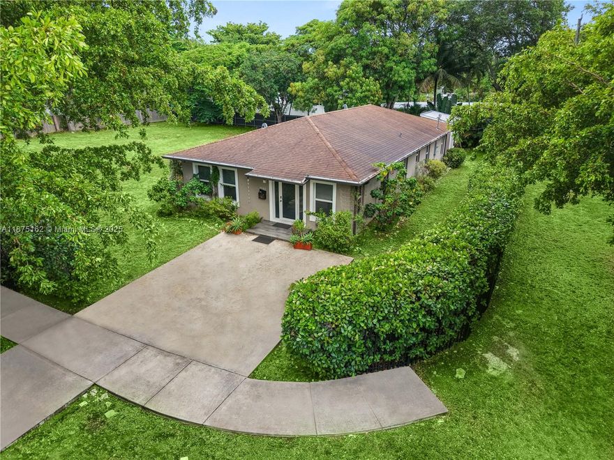 Exceptional 2019 home on an expansive 18,600 sqft corner lot. An open floor plan filled with natural light from hurricane-impact windows connects spacious living and dining areas to a sleek kitchen with high-end appliances, including a glass cooktop and dishwasher. Three generously sized bedrooms and two thoughtfully designed baths , and inside laundry for everyday convenience. Step outside to a patio and yard framed by mango and avocado trees, creating a peaceful, tropical setting to enjoy year-round. A detached backyard structure provides versatile space for a studio, guest quarters, or workspace. The oversized lot is large enough to subdivide and build an additional residence, with two separate water meters and a gated entry for independent access, offering unique development potential.