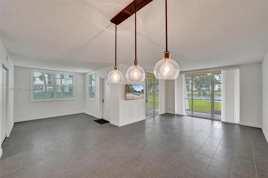 Rarely available and truly a one-of-a-kind opportunity! This stunning 3-bedroom, 2-bathroom corner unit offers over 1,260 square feet of luxury living and has been completely remodeled from top to bottom. Located in the highly sought-after private country club community of Pine Island Ridge, this bright and airy residence features breathtaking water views and an expansive wraparound screened-in porch—perfect for relaxing or entertaining.  Inside, you’ll find tile flooring throughout, a beautifully updated kitchen with new appliances, and fully renovated bathrooms with modern finishes. Plantation shutters add elegance and charm, while the open layout allows for abundant natural light to flow throughout the home. The third bedroom wall has been opened up to create additional living space, offering flexibility for a den, office, or expanded living area—easily converted back if desired. Every detail has been thoughtfully upgraded, making this unit truly move-in ready. Enjoy resort-style living with the Pine Island Ridge Country Club included in your condo fee, featuring a full gym, two restaurants, golf, tennis, pool, and play area. This is an all-ages community in a prime location close to everything. Rentals are not permitted.  A rare find with incredible views, luxury upgrades, and unbeatable amenities—this one will not last!