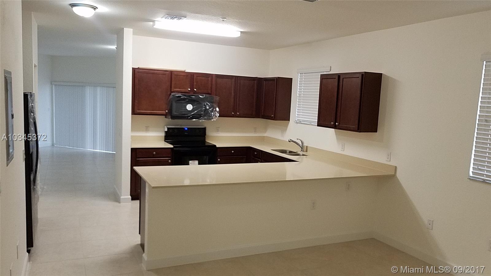 Bright brand new construction, close to major highways, READY TO MOVE-IN. Two-story 3/2.5 spacious condo. Stainless steel appliances, energy efficient central AC, large closets, two parking spaces assigned, terrace, and security guard.