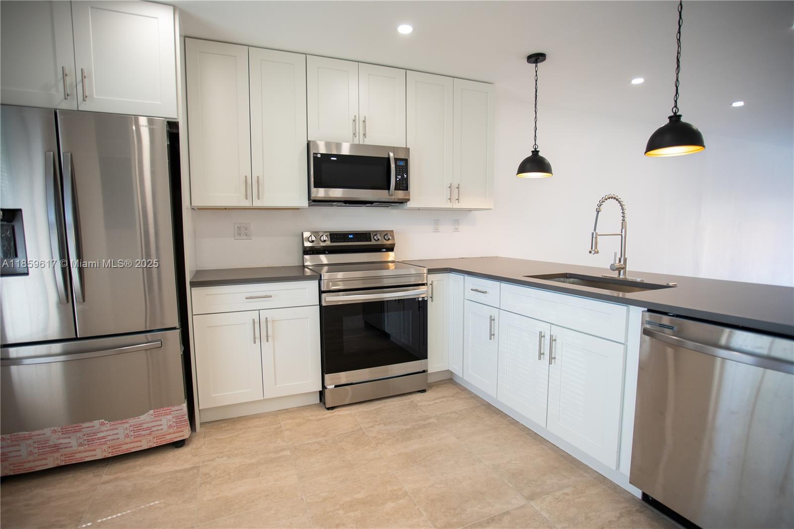 Rarely available and completely remodeled light and bright villa in desirable Nova North. Featuring 1400 sq feet of space to spread out and feel at home. The open concept kitchen features quartz countertops, stainless steel appliances & white cabinets. Convenient washer/dryer and two reserved parking spaces. Extra large spacious family room/dining area along with neutral tile floors and bright LED recessed lighting throughout. New blinds, light fixtures including ceiling fans in every bedroom. The outside fenced patio features a paved concrete floor, great for grilling and enjoying the outdoors. Nova North is conveniently located within a few short minutes to Nova University, Tower Shops and many other, shops, restaurants and schools. Commuting? No problem, 595 and I-75 are minutes away.