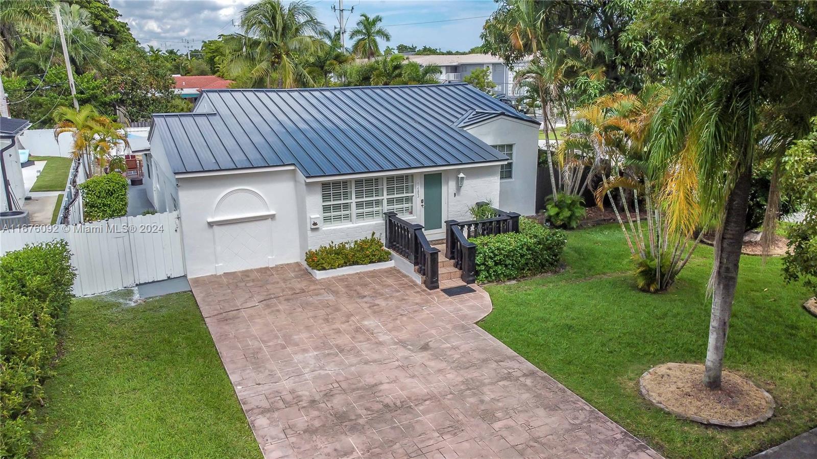 Beautiful corner pool home with a backyard oasis! This updated 3-bed, 2-bath residence boasts an open-concept kitchen with granite countertops, stainless steel appliances, recessed lighting, and impact windows/doors. Wood flooring flows through the kitchen, living, dining, and living room areas, while life-proof vinyl plank flooring enhances the bedrooms, Florida room, laundry area, and entryway. The home also features a new metal roof. Outside, enjoy lush landscaping, a sparkling pool, and a fenced backyard. Driveway parking fits up to 4 cars, and plantation shutters on the front windows add extra charm. Ideally located minutes from Downtown Hollywood, Young Circle, shopping, dining, and the beach.