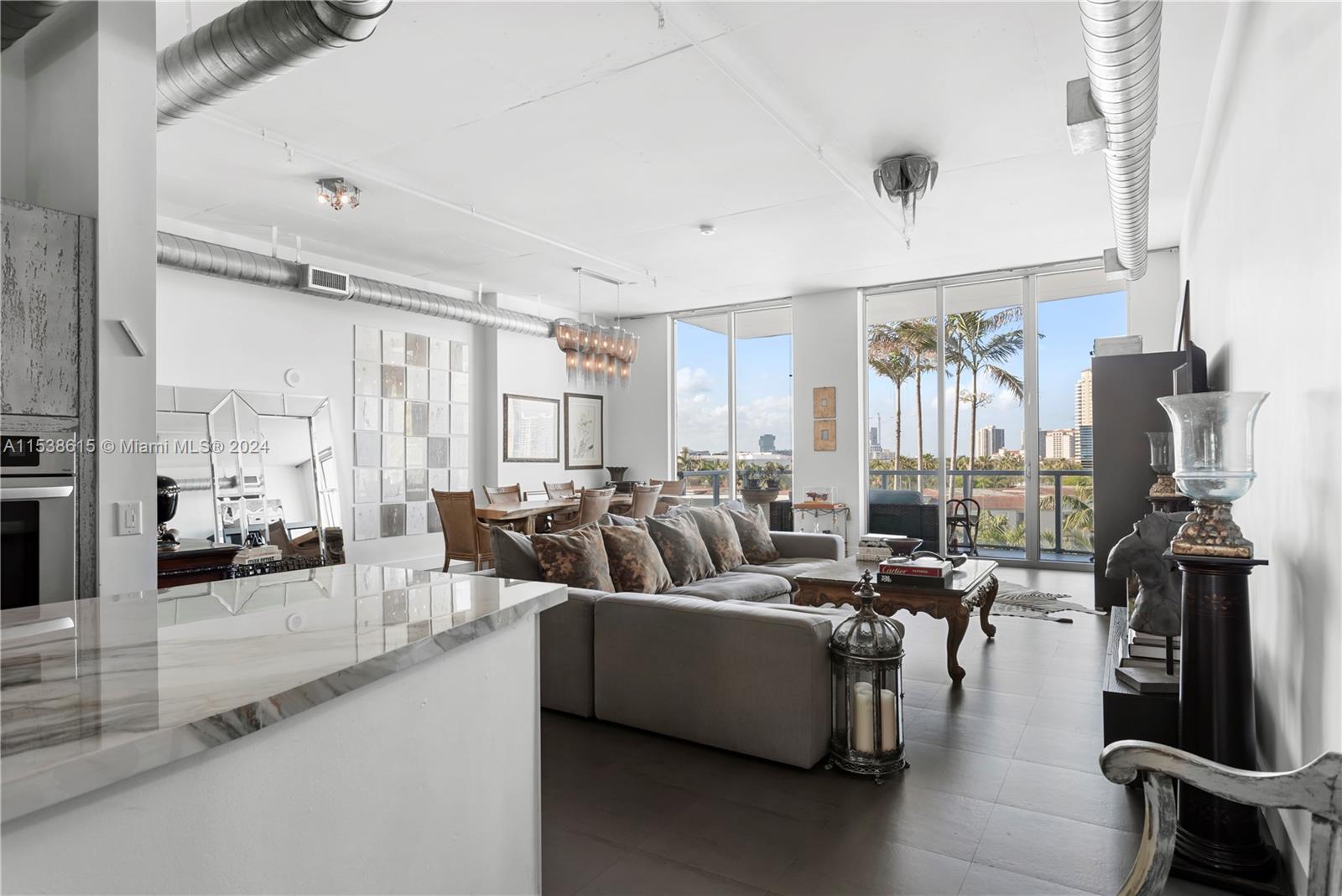 Experience unparalleled luxury in the heart of Aventura with this meticulously remodeled loft-style residence. Soaring 11-ft ceilings and floor-to-ceiling windows infuse the space with natural light, complemented by an in-unit washer and dryer and tastefully designed kitchen. Two private balconies. Indulge in resort-style living with amenities like an infinity-edge pool, jacuzzi, basketball and tennis courts, fitness center, steam and sauna rooms, business center, 24-hour valet parking, and a dedicated concierge. The residence is steps away from Aventura Mall and a short drive from Bal Harbour Shops, surrounded by dining and entertainment options. The Uptown Marina Lofts neighborhood boasts a Charter School and a Community Recreation Center, adding to the convenience and community spirit.