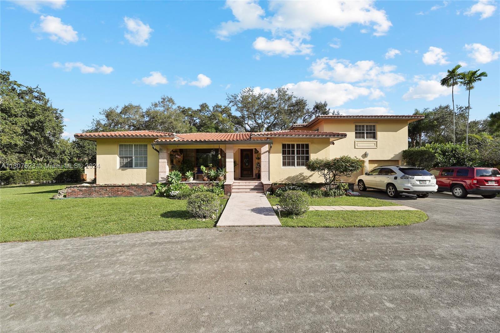 Exceptional home on almost one-acre corner lot. Surrounded by majestic, mature trees and picturesque native landscaping. Large 4-bed, 5-bath with separate area for offices and/or guest house. Delightful large pool with cabana and outdoor bath. 6-car garage with additional parking in driveway. Classic kitchen with granite countertops, gas stove, double sinks, adjacent to daily dinning room facing the pool and back yard, as well as formal dinning room. Inviting family room/library, appealing formal living room in addition to 3 bedrooms downstairs, each with its own bath. Upstairs main bedroom/bath and large family room and 2 guest bedrooms/baths. This is truly a one of a kind property in a great location. A must-see. Original home was built in 1937, additional area was constructed in 1950.