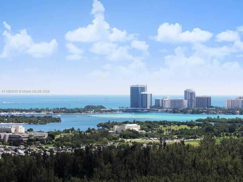 Large floor plan corner unit. 2,385 SF living space. 3 bedrooms plus a den, large closets, 3 bathrooms plus half bath. Unobstructed panoramic views of the Ocean, Oleta River Park, Crystal Lagoon & Miami skyline. Great amenities, clubroom, heated pool, gym, tennis court, playground, dog park, valet parking. Water, basic cable, internet, amenities, motorcycle & bike room, 4 EV charging stations included with HOA fees. One assigned covered parking space, additional spots can be rented for $65/month. No more land-lease, land has been purchased. Assessments to be paid in full at closing.