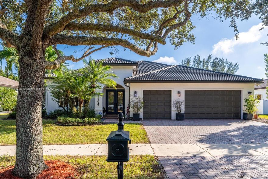 Luxury living in gated Hibbs Grove in Cooper City.  This 4 bed, 3 bath pool home sits on an expansive 22,500_ SF lot (over 1/2 acre lot) with desirable triple split floor plan, 3 car garage, and spacious open concept layout. Featuring remodeled kitchen with quartz countertops and waterfall, upgraded tile flooring, modern LED lighting, and curated interior designed by Joanna D. Home includes screened patio, pool, custom tiki hut with outdoor kitchen and bar seating, built in grill, fridge, full electric and water. Close to top schools including Cooper City H.S. , Griffin Elementary, University School NSU, American Heritage, Archbishop McCarthy, and more.Lu