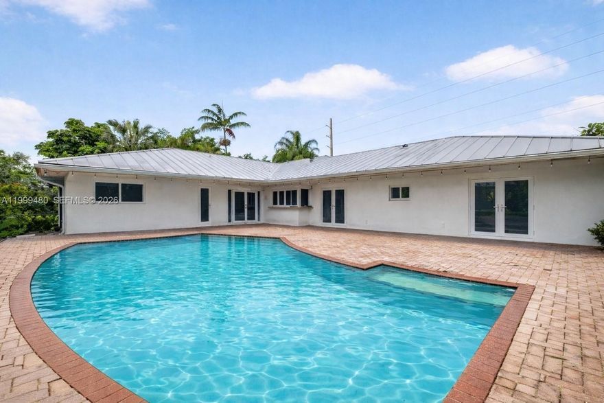 Beautifully maintained home in the heart of Palmetto Bay, offering 4 bedrooms, 2.5 bathrooms and 2,860 SF, set on a lush 18,750 SF corner lot on a quiet, low traffic street.

Features a desirable split floor plan with a private primary suite, tile floors throughout, and abundant closet space. Spacious family room and a well equipped kitchen, perfect for everyday living and entertaining. Laundry room with sink adds convenience.

Enjoy your private saltwater pool, ideal for relaxing or hosting year round. Additional highlights include a circular driveway, 2 car garage, and durable metal roof. Gas water heater, washer and dryer.

Located near top rated schools, including Coral Reef Senior High School and Elementary, plus parks, shopping, and dining nearby. 
DU required with offer. 
AI-enhanced photos; decluttering only, no structural changes.